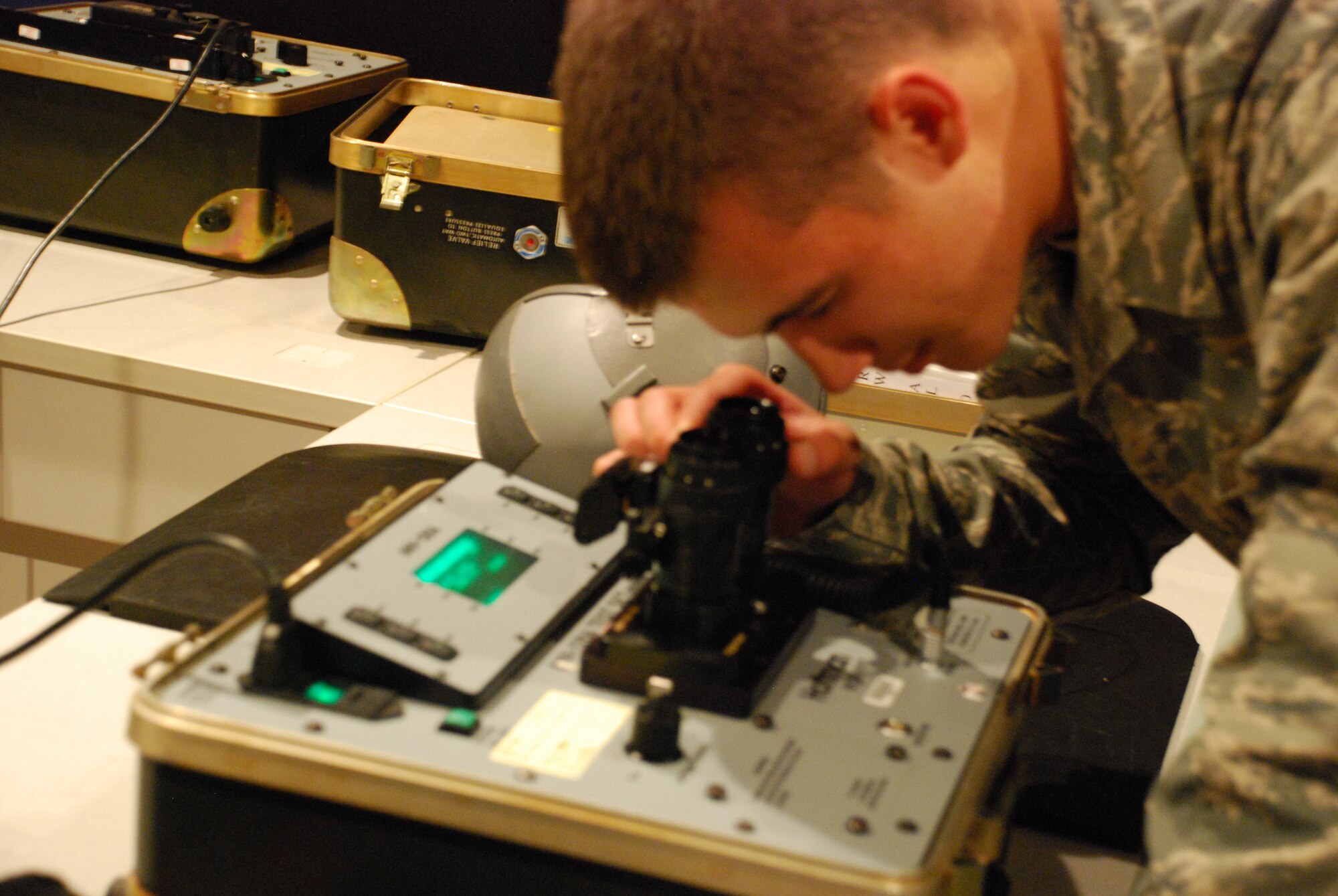 As part of a 180-day inspection requirement for every Aircrew Flight Equipment technicians, Airman Greg Steele, 381st Training Squadron student, calibrates the G-Model night vision goggles on the 126A-tester May 26, 2010, at Sheppard Air Force Base, Texas. The tester allows for troubleshooting the NVGs after encountering any problem after flight. (U.S. Air Force photo/Airman 1st Class Valerie Hosea)