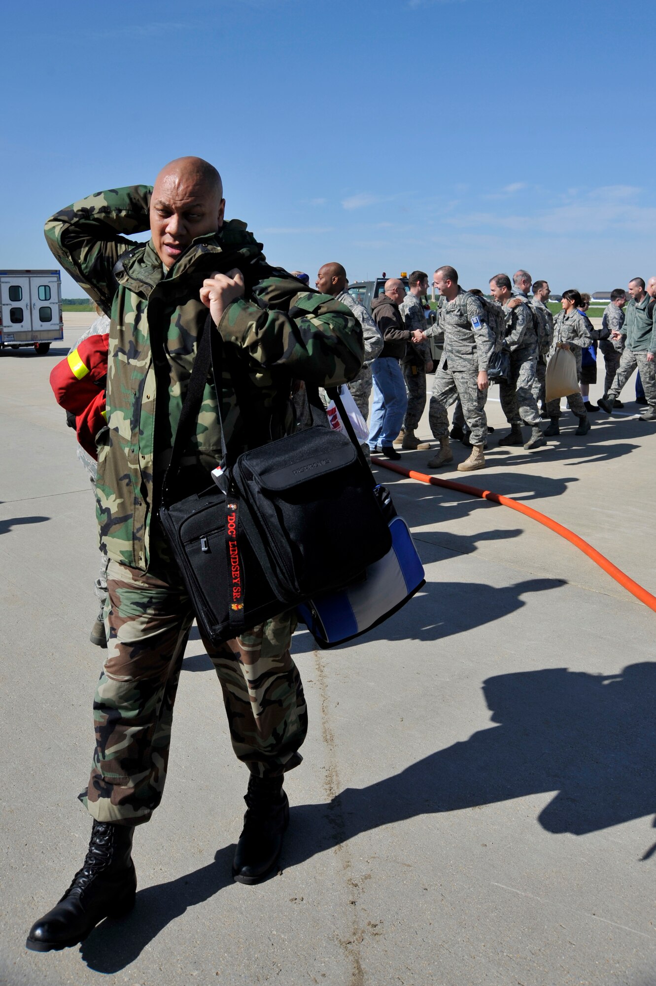 Members of the 459th Air Refueling Wing head out for a deployment April 27.  Before boarding a KC-135R Stratotanker, which is also deploying, the servicemembers shake the hands and receive well wishes from their co-workers and supervisors.  Approximately 20 percent of the 459th ARW deployed as units and individual augmentees this spring in support of operations in the Pacific and Southwest Asia (U.S. Air Force photo/ Staff Sgt. Perry Aston).
