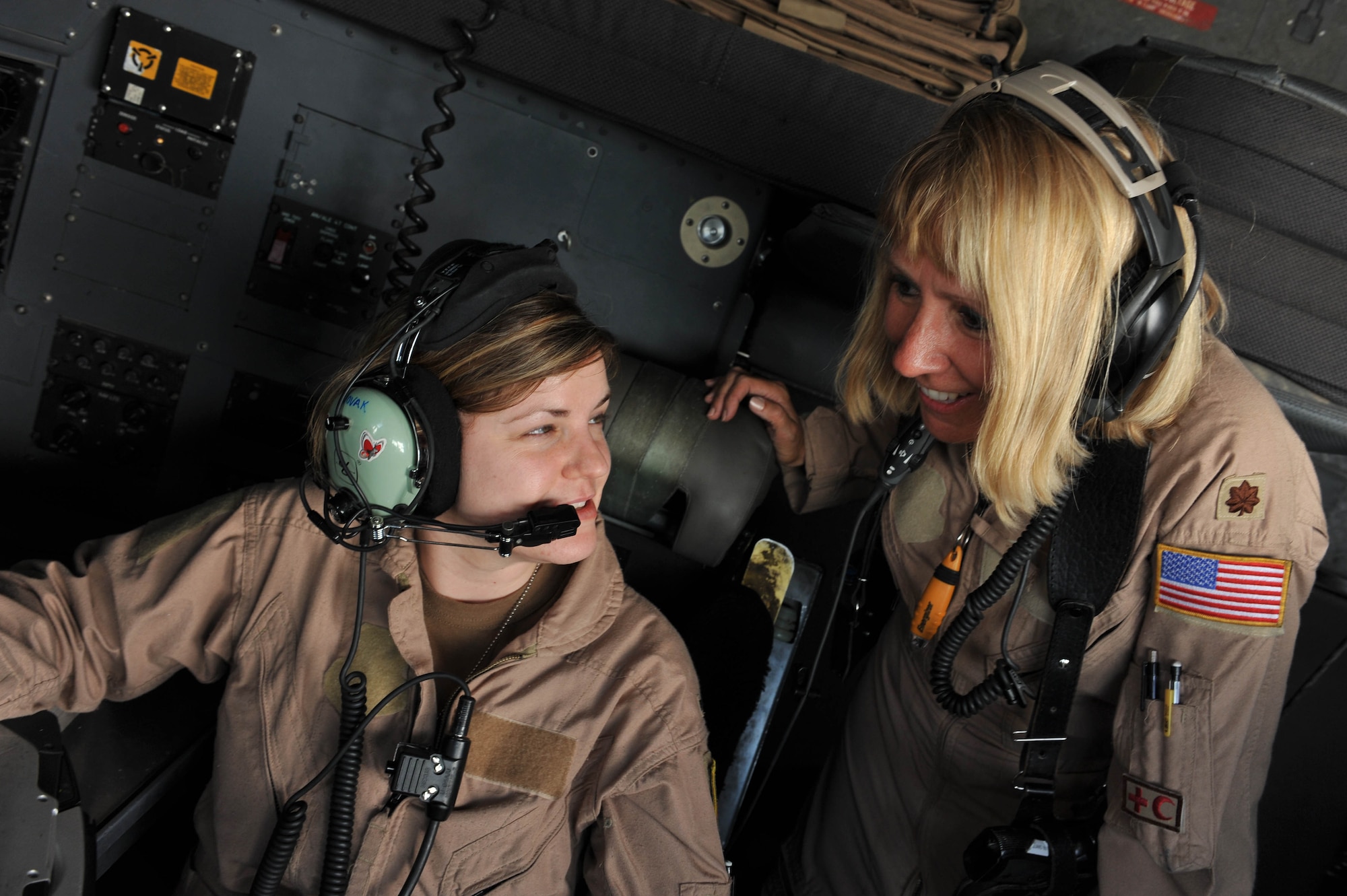 U.S. Air Force navigator, 1st Lt. Kimberly Novak, talks with flight nurse Maj. Lisa Giugliano during an aeromedical evacuation mission in Iraq, May 13, 2010.  Major Giugliano is deployed to the 332nd Expeditionary Aeromedical Evacuation Flight and Lieutenant Novak is assigned to the 777th Airlift Squadron, Joint Base Balad, Iraq.  (U.S. Air Force photo/Staff Sgt. Quinton Russ/released)