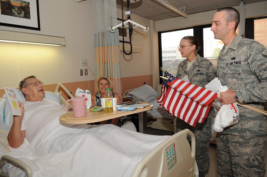 DURHAM, N.C. -- Airmen from Seymour Johnson Air Force Base deliver gifts to retired Master Sgt. Fred Harrell during a visit to the Durham Veteran Affairs Medical Center, May 21, 2010. The visiting Airmen gave veterans at the center cards made by Greenwood Middle School 5th graders, flags and comfort kits donated by the American Red Cross. Mr. Harrell, former United States Marine Corp supply technician, hails from Goldsboro. (U.S. Air Force photo/Staff Sgt. Courtney Richardson)