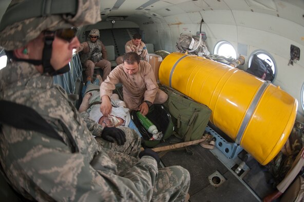 Aboard an Iraqi air force Mi-17, Iraqi AF medics care for an injured Iraqi policeman during a flight to Almuthana Hospital, Baghdad, while U.S. air Force medical advisors train and observe their techniques.  The patient will then be taken to Medical City Hospital by ambulance, where he will receive further care. (U.S. Air Force photo by Senior Master Sgt. Elizabeth Gilbert/released)