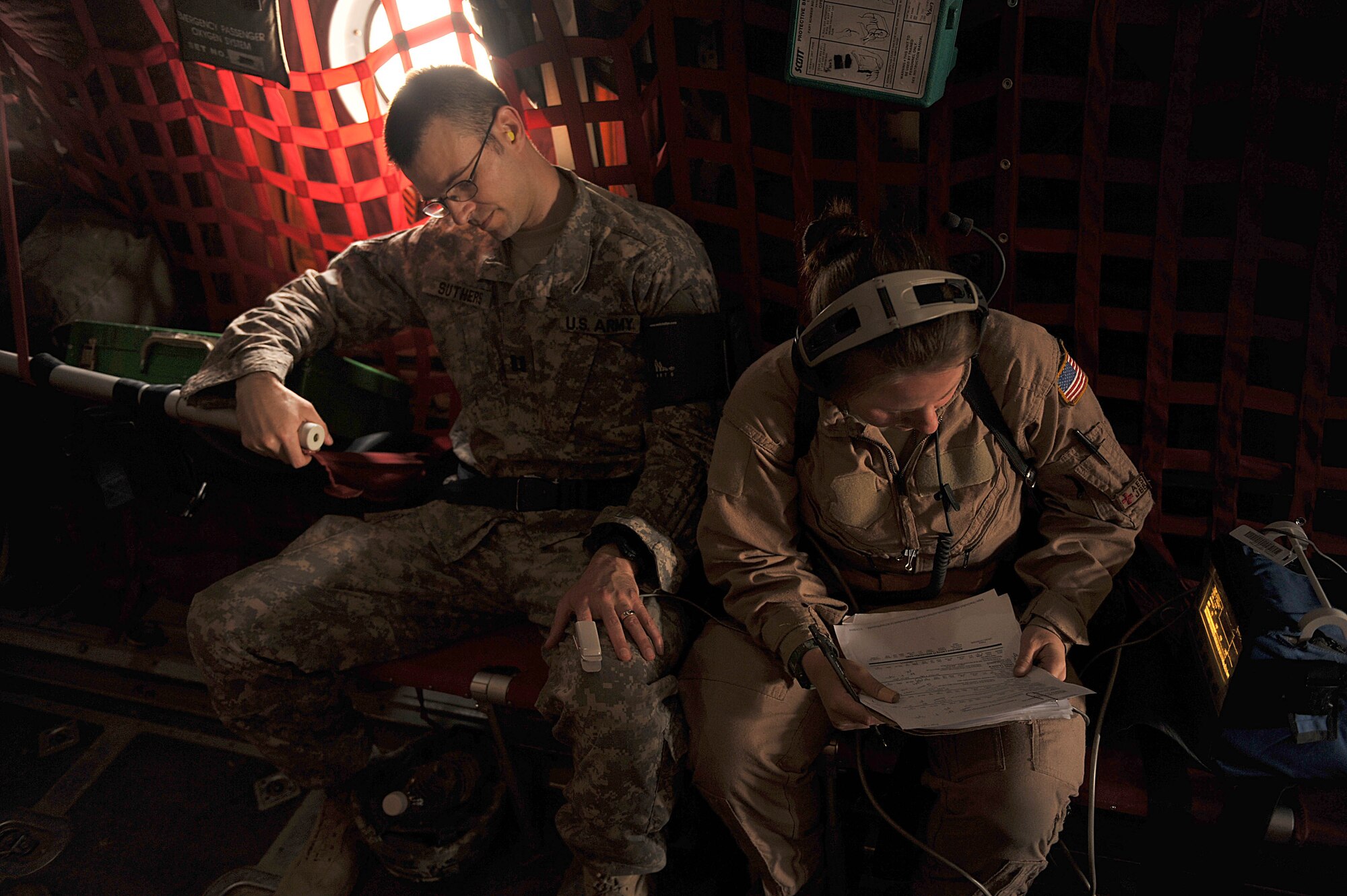 U.S. Air Force medical technician, Staff Sgt. Deida Sturges, right, writes down a patient's blood pressure during an aeromedical evacuation mission in Iraq, May 13, 2010.  Sergeant Sturges is deployed to the 332nd Expeditionary Aeromedical Evacuation Flight, Joint Base Balad, Iraq.  (U.S. Air Force photo/Staff Sgt. Quinton Russ/released)