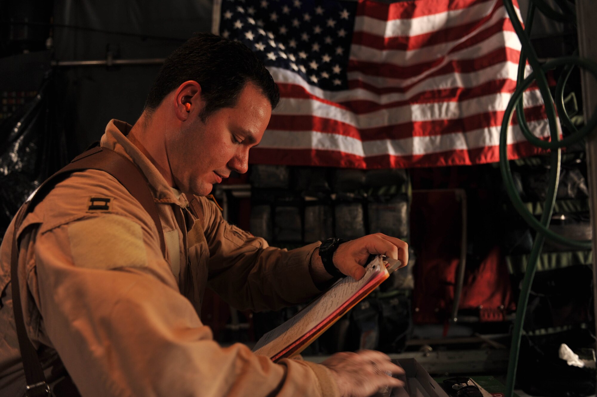 U.S. Air Force flight doctor, Capt. James Moses, goes over a patient's chart during an aeromedical evacuation mission in Iraq, May 13, 2010.  Doctor Moses is deployed to the 332nd Expeditionary Aeromedical Evacuation Flight, Joint Base Balad, Iraq.  (U.S. Air Force photo/Staff Sgt. Quinton Russ/released)