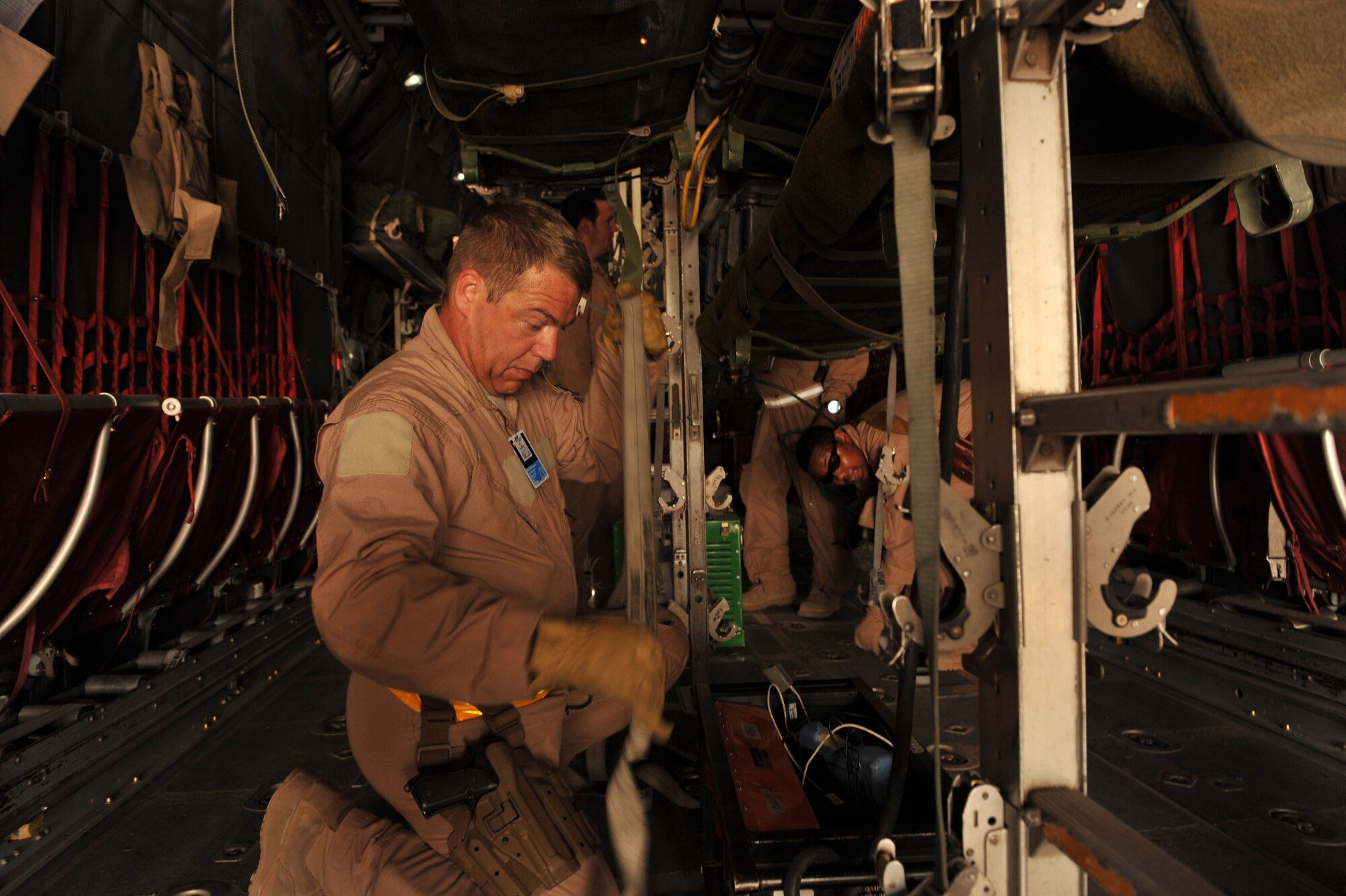 U.S. Air Force medical technician, Tech. Sgt. Sean Kassebaum, configures a C-130 Hercules for an aeromedical-evacuation flight at Joint Base Balad, Iraq, May 13, 2010.  Sergeant Kassebaum is deployed to the 332nd Expeditionary Aeromedical Evacuation Flight, Joint Base Balad, Iraq.   (U.S. Air Force photo/Staff Sgt. Quinton Russ/released)