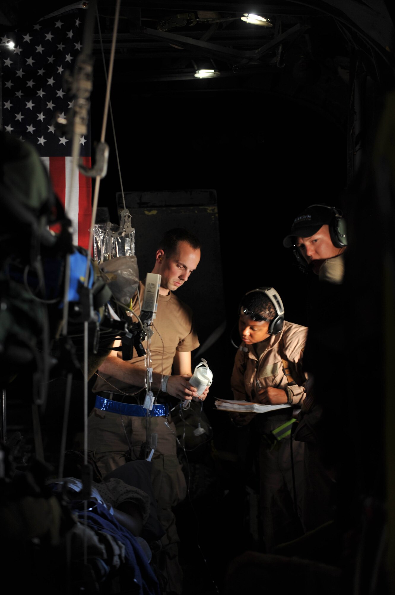U.S. Navy Lt. J. G. Joshua Wymer and Air Force Tech. Sgt. Melinda Ford go through a patient's IV bag during an aeromedical evacuation flight, May 13, 2010.  Lieutenant Wymer is deployed to the Emergency Medical Facility, Southwest Asia, and Sergeant Ford is deployed to the 332nd Expeditionary Aeromedical Evacuation Flight, Joint Base Balad, Iraq.  (U.S. Air Force photo/Staff Sgt. Quinton Russ/released)