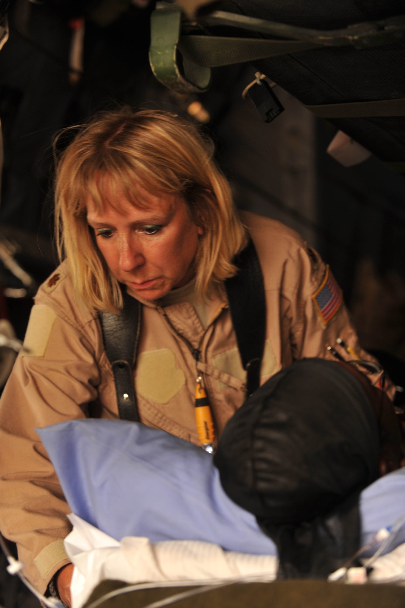 U.S. Air Force AE Mission Crew Director and flight nurse, Maj. Lisa Giugliano, checks on a patient during an aeromedical evacuation flight from Southwest Asia to Joint Base Balad, Iraq, May 13, 2010.  Maj. Giugliano is deployed to 332nd Expeditionary Aeromedical Evacuation Flight, Joint Base Balad, Iraq.  (U.S. Air Force photo/Staff Sgt. Quinton Russ/released)