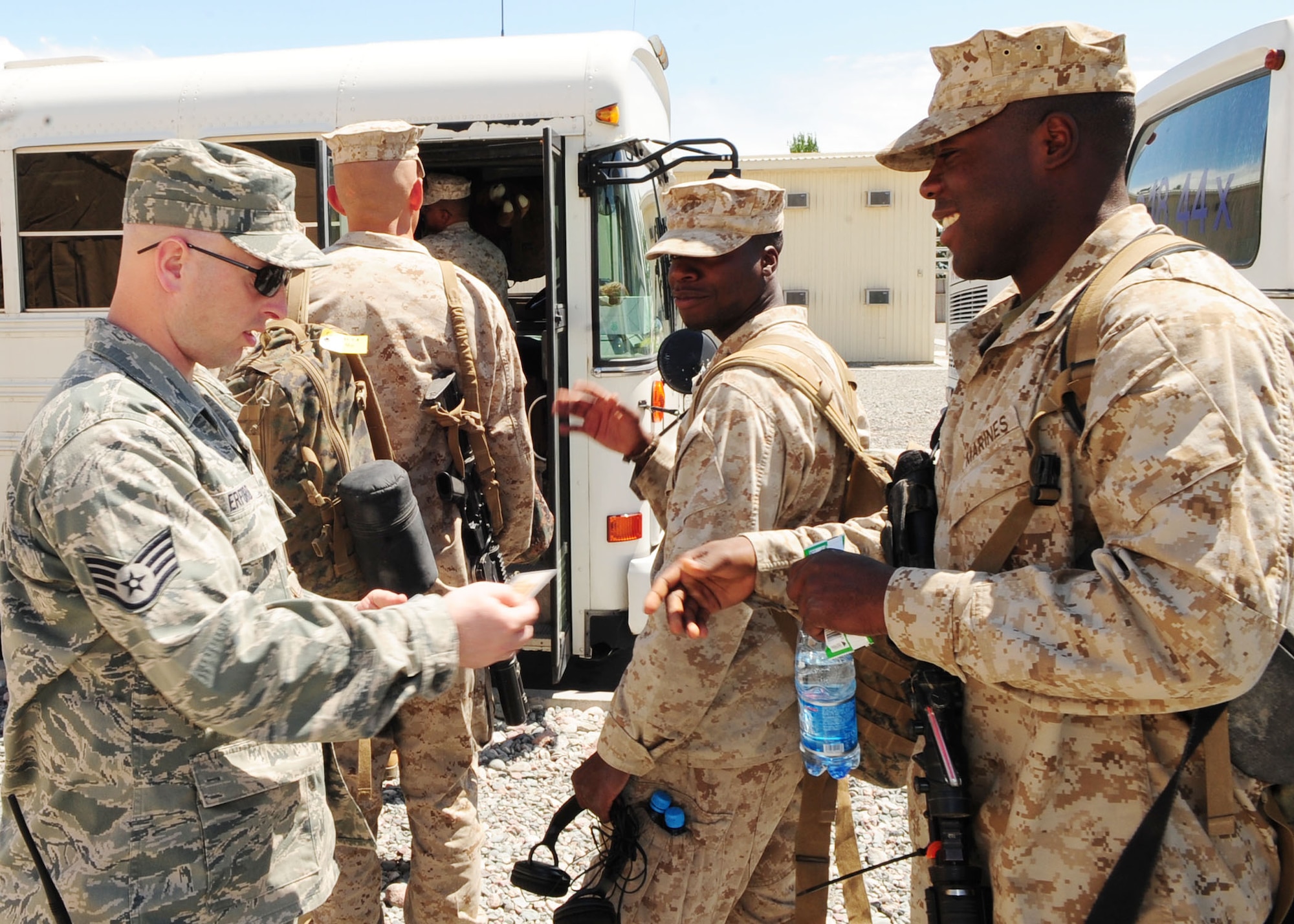 Staff Sgt. Wyatt Erford, a 376th Expeditionary Logistics Readiness Squadron passenger service agent, takes boarding passes from Marines headed home from Afghanistan to Cherry Point, N.C., via the Transit Center at Manas, Kyrgyzstan. His 35-person team processed a record-breaking 4,200 members May 16, 2010, and is likely to break a monthly record by processing more than 52,000 by the end of the month. (U.S. Air Force photo/Senior Airman Nichelle Anderson / released)