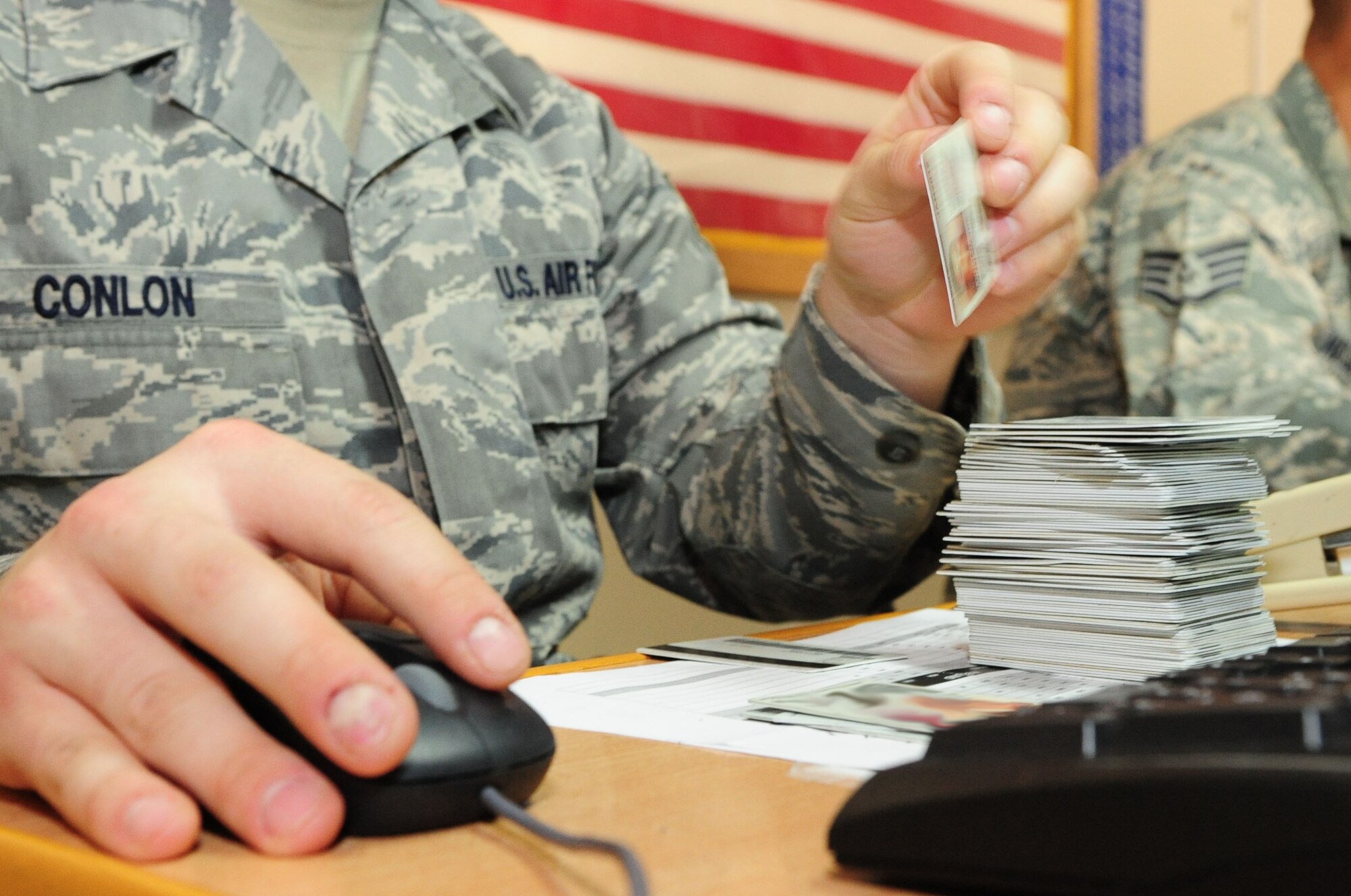 Senior Airman Stephen Conlon, a 376th Expeditionary Logistics Readiness Squadron passenger service agent processes identification cards for military service members scheduled to leave the Transit Center at Manas, Kyrgyzstan, to go into or out of the AOR. The 35 Airmen working at the Transit Center?s passenger terminal processed a record-breaking 4,200 members May 16, 2010, and is likely to break a monthly record by processing more than 52,000 by the end of the month. (U.S. Air Force photo/Senior Airman Nichelle Anderson / released)
