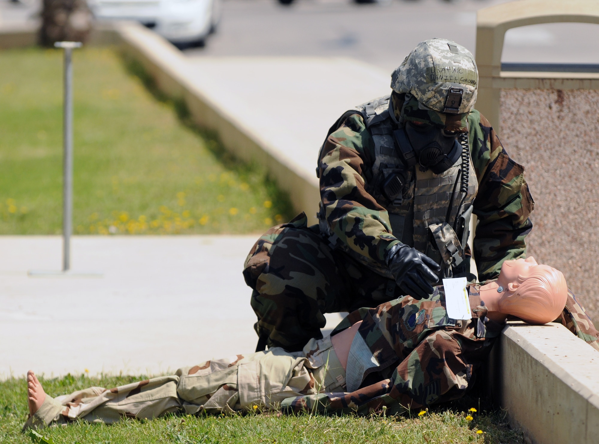 Airman 1st Class Daniel Coronado, 39th Security Forces Squadron, checks on a “victim” of a simulated chemical attack during an anti-terrorism exercise Tuesday, May 25, 2010 at Incirlik Air Base’s fitness center.  The exercise tested the base’s terrorism-response ability.  The base was put into 24-hour operations for the duration of the exercise and accomplished a number of simulated artillery and chemical attacks.  (U.S. Air Force photo/Staff Sgt. Raymond Hoy)