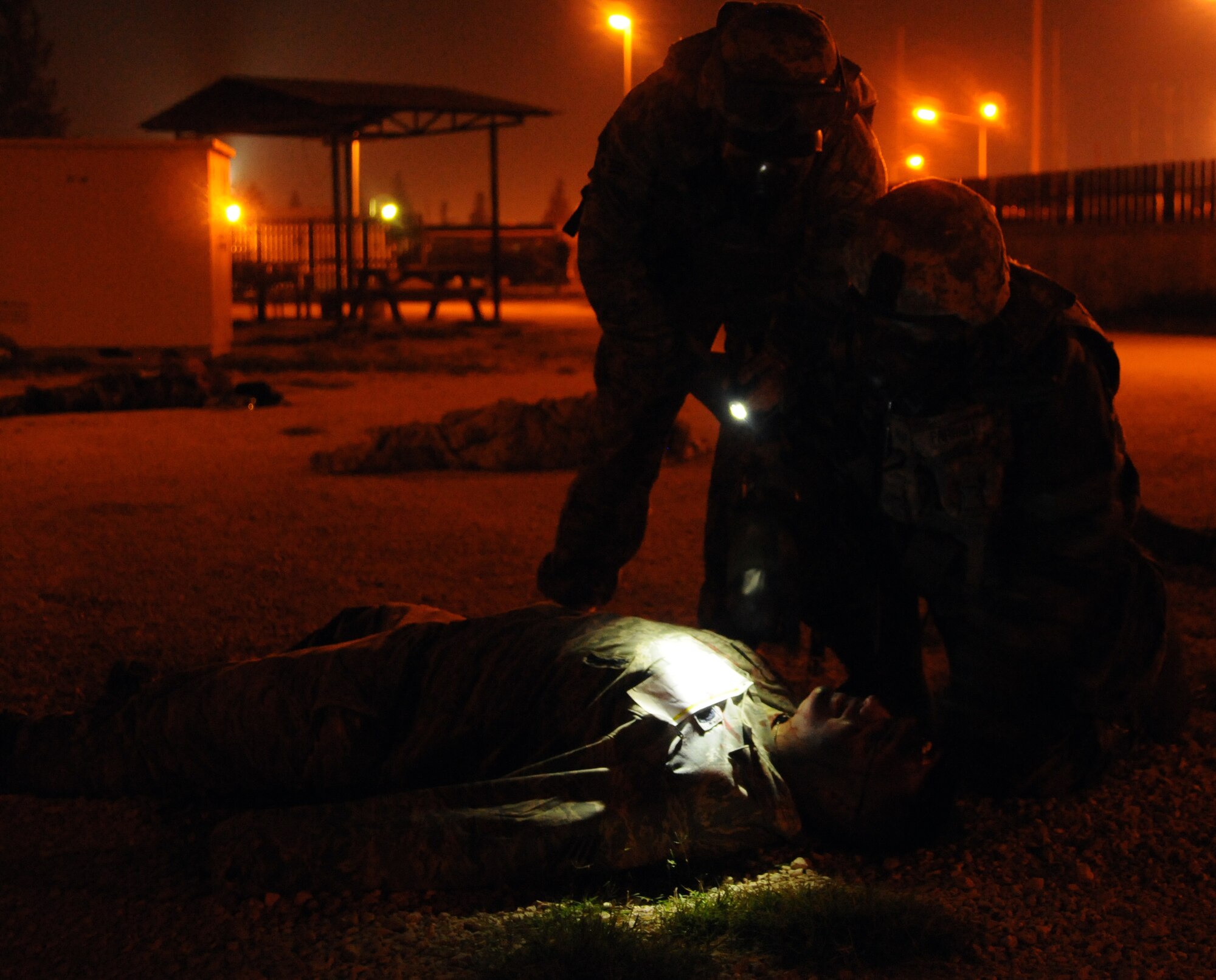 First responders check on a “victim” following a simulated chemical attack during an anti-terrorism exercise Tuesday, May 26, 2010 at Incirlik Air Base’s Patriot Village.  The exercise tested the base’s terrorism-response ability.  The base was put into 24-hour operations for the duration of the exercise and accomplished a number of simulated artillery and chemical attacks.  (U.S. Air Force photo/Staff Sgt. Raymond Hoy)