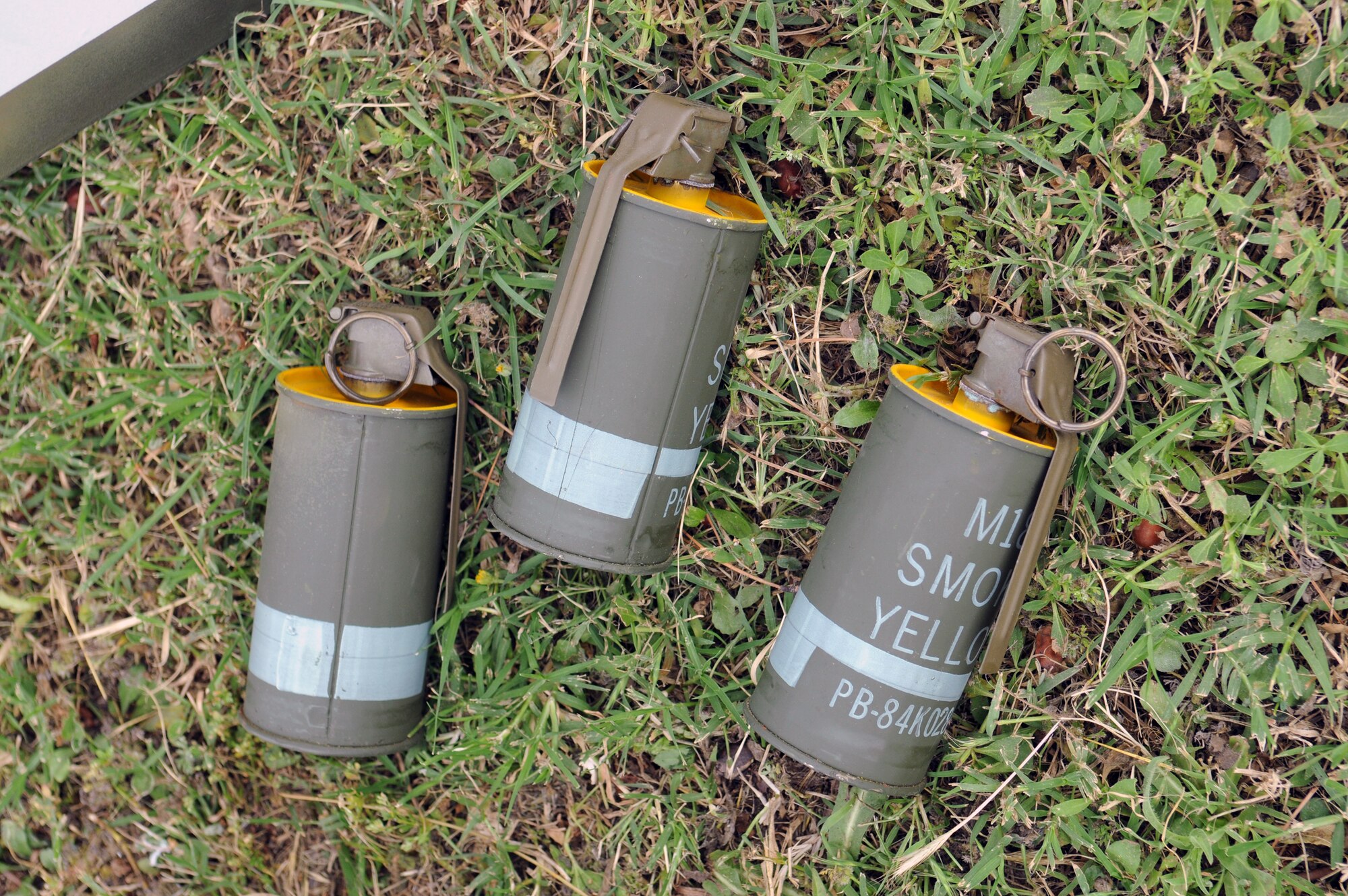 Cans of yellow smoke are used to simulate a chemical attack during an anti-terrorism exercise Tuesday, May 25, 2010 at Incirlik Air Base’s Freedom Park.  The exercise tested the base’s terrorism-response ability.  The base was put into 24-hour operations for the duration of the exercise and accomplished a number of simulated artillery and chemical attacks.  (U.S. Air Force photo/Staff Sgt. Raymond Hoy)