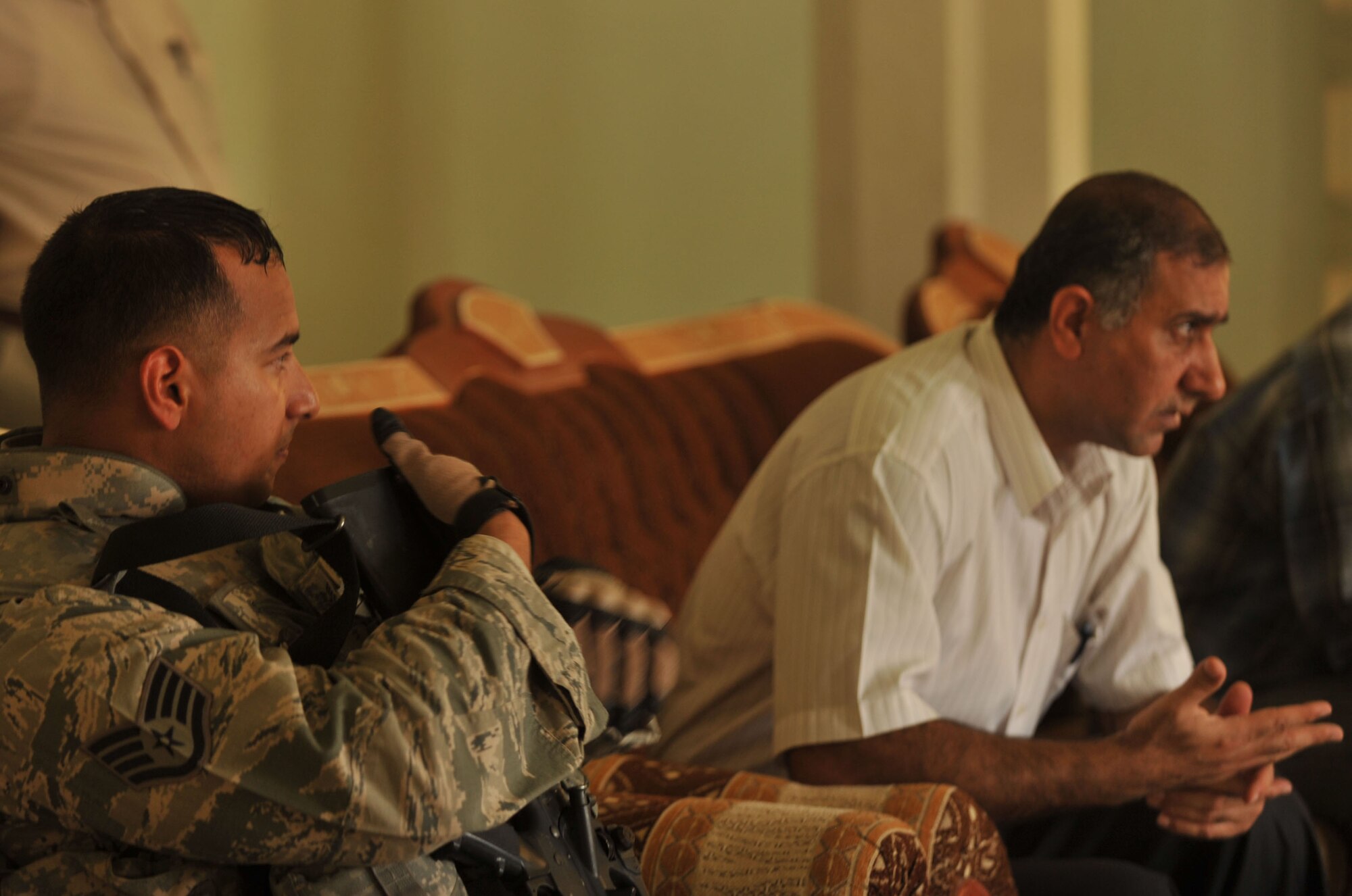 U.S. Air Force firefighter, Staff Sgt. Steven Sanabria, listens to the Iraqi fire chief discuss training and equipment in Bakir Village, Iraq, May 7, 2010.  Sergeant Sanabria is deployed to the 332nd Expeditionary Civil Engineer Squadron, Joint Base Balad, Iraq.  (U.S. Air Force photo/Staff Sgt. Quinton Russ/released)	