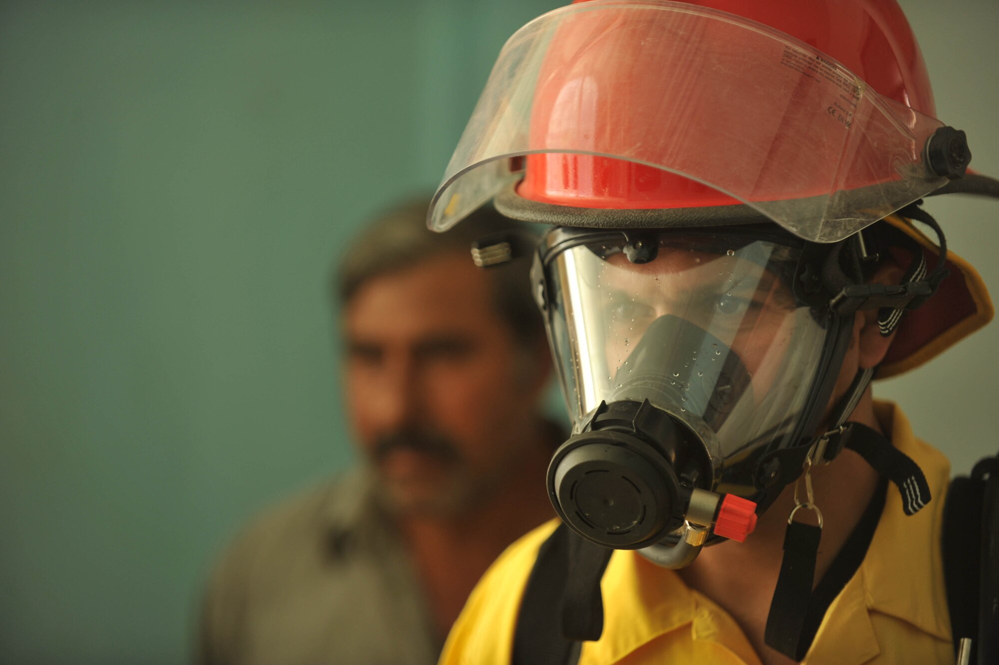 An Iraqi volunteer firefighter tries on fire-protection equipment at Bakir Village, Iraq, May 7,2010.  (U.S. Air Force photo/Staff Sgt. Quinton Russ/released)	
