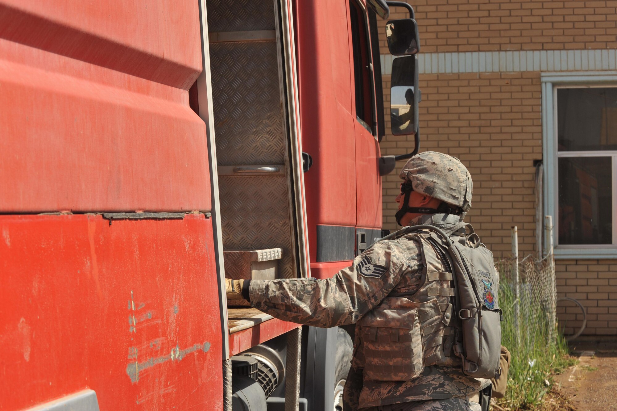 U.S. Air Force firefighter Staff Sgt. Jacob Barrey looks at an Iraqi fire truck and equipment at Bakir Village, Iraq, May 7, 2010. Barrey is deployed to the 332nd Expeditionary Civil Engineers Squadron, Joint Base Balad, Iraq.  (U.S. Air Force photo/Staff Sgt Quinton Russ/released)