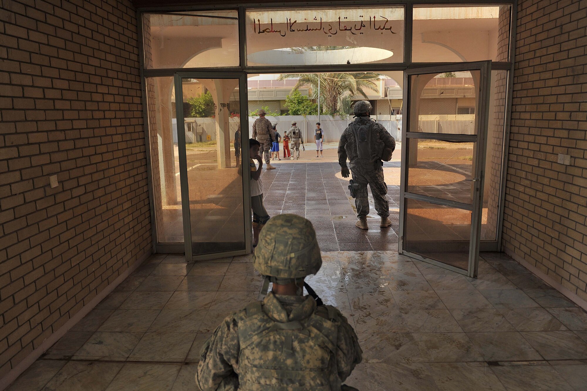U.S. Army Pfc. Jose Herrera posts guard inside the firehouse at Bakir Village, Iraq, May 7, 2010.  Private Herrera is assigned to the 1st Battalion, 28th Infantry, Delta Company Black Lions, 3rd Platoon, Ft. Riley, Kan.  (U.S. Air Force photo/Staff Sgt. Quinton Russ/released)