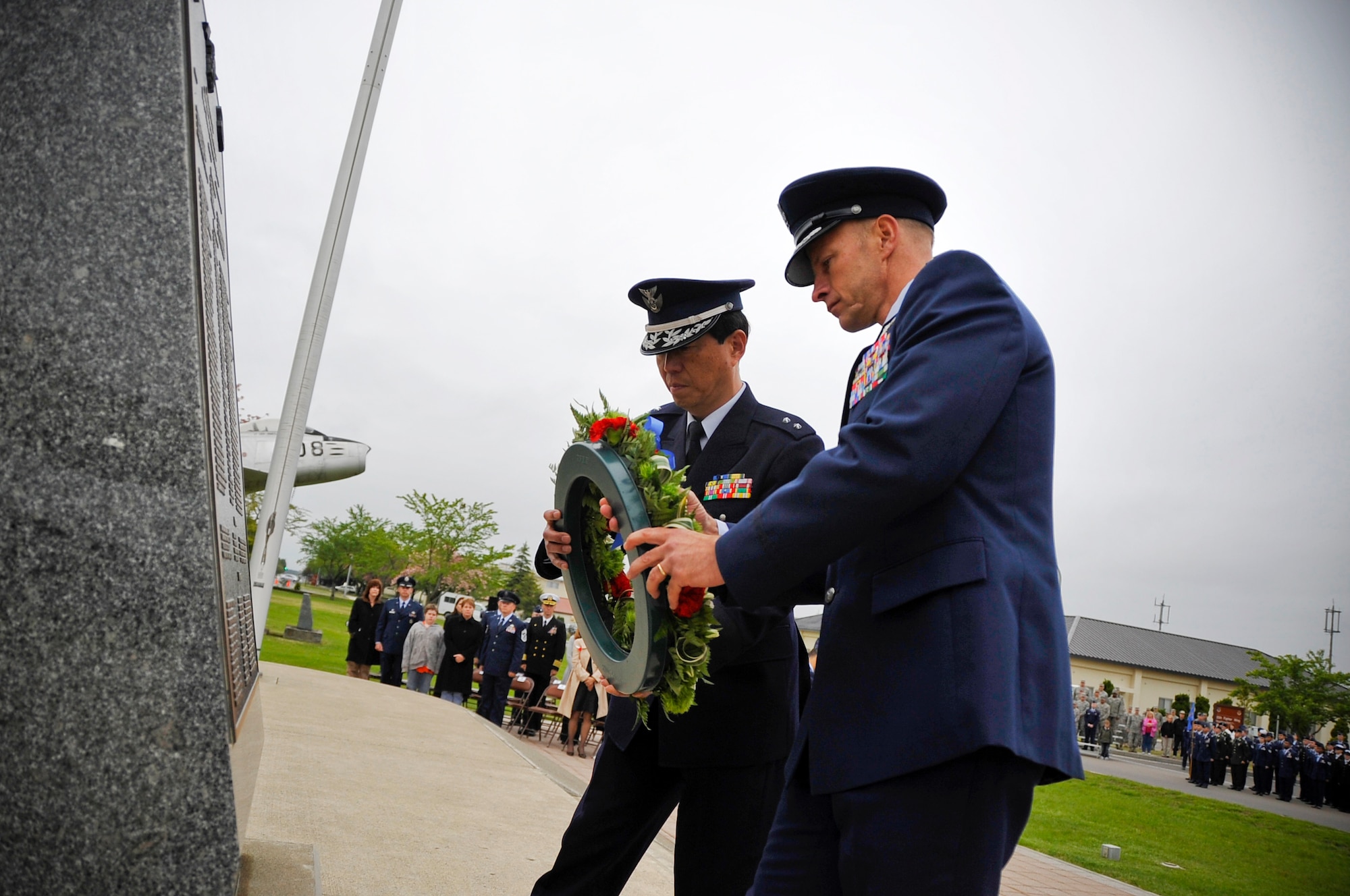 MISAWA AIR BASE, Japan -- Col. RC Craig, 35th Fighter Wing vice commander and Japan Air Self-Defense Force Maj. Gen. Kozo Ishino, Northern Air Defense Force vice commander, lay the ceremonial wreath at the base of the U.S. and Japanese flags during the Memorial Day retreat ceremony May 27. The ceremony was held in honor of service members who died while defending freedom in wars past and present. (U.S. Air Force photo/Staff Sgt. Chad C. Strohmeyer)