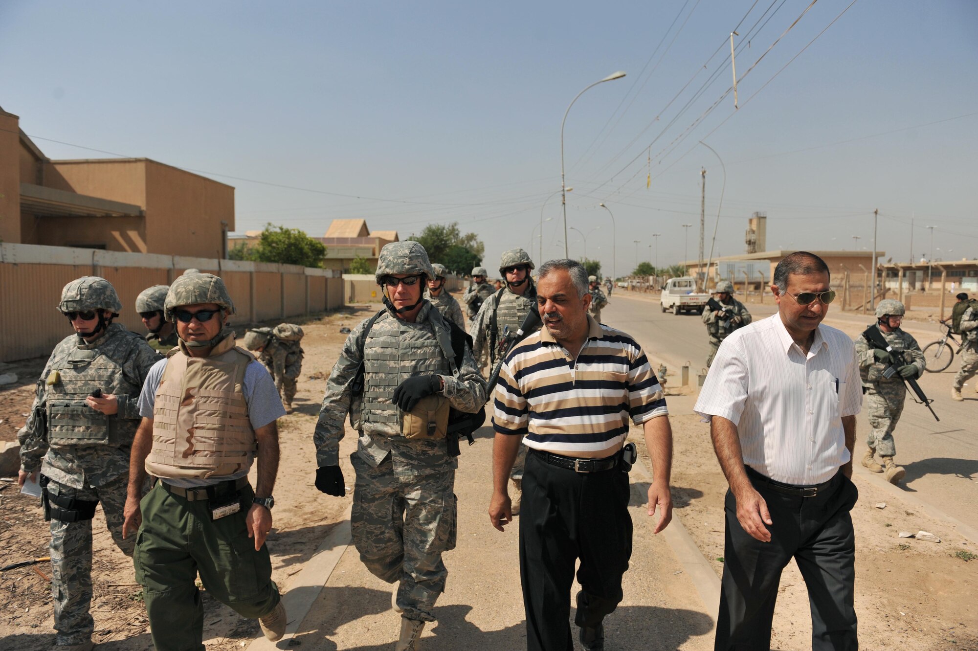 Chief Master Sgt. David Fain walks with Fire Chief Basim Muhammad Saleh to the Iraqi fire station in Bakir Village, Iraq, May 7, 2010.  Chief Fain is the fire chief for the 332nd Expeditionary Civil Engineer Squadron, Joint Base Balad, Iraq.  (U.S. Air Force photo/Staff Sgt. Quinton Russ/released)	