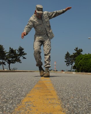 Master Sgt. William Carson, 8th Fighter Wing flight safety non-commissioned officer tested goggles that simulate varying percentages of blood alcohol content levels, at Kunsan Air Base, Republic of Korea, May 26, 2010. People will be asked to drive a golf cart in a restricted area while wearing these goggles. The purpose of this is to simulate the impairment caused by alcohol and its effects while driving. (U.S. Air Force Photo/Senior Airman Roy Lynch) 
