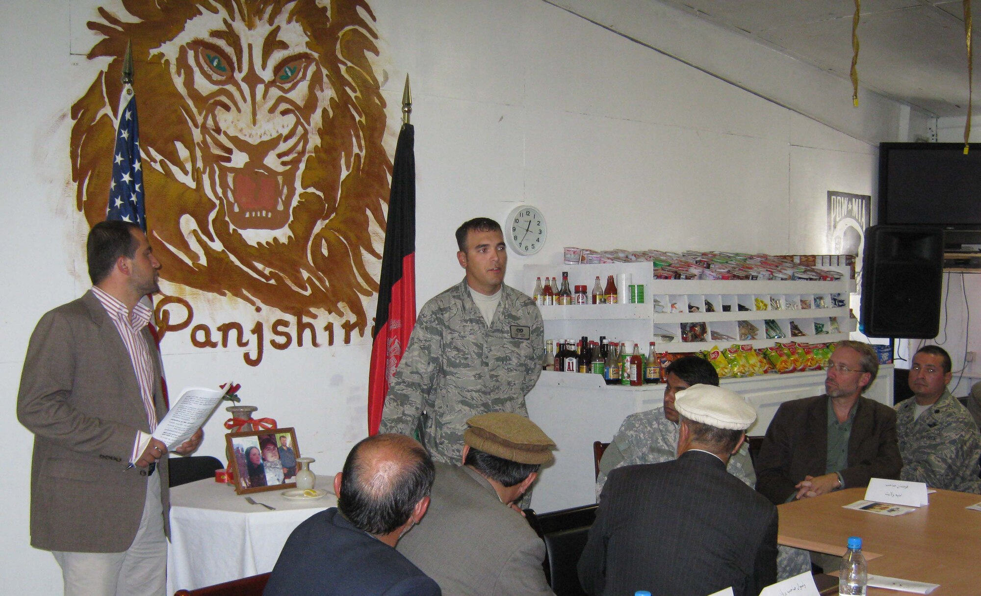 PANJSHIR PROVINCE, Afghanistan ? (Standing on right) U.S. Air Force Staff Sgt. Teddy Rivera, Provincial Reconstruction Team Panjshir vehicle operator and Fayetteville, N.C., native, participates in the ?Tribute to Our Fallen Comrades? portion of a remembrance ceremony May 26 at Forward Operating Base Lion. A crowd of PRT members and guests gathered for the ceremony that paid tribute to four PRT members who were killed in action one year earlier. (Photo by U.S. Air Force 2nd Lt. Jason Smith, Provincial Reconstruction Team Panjshir Public Affairs)