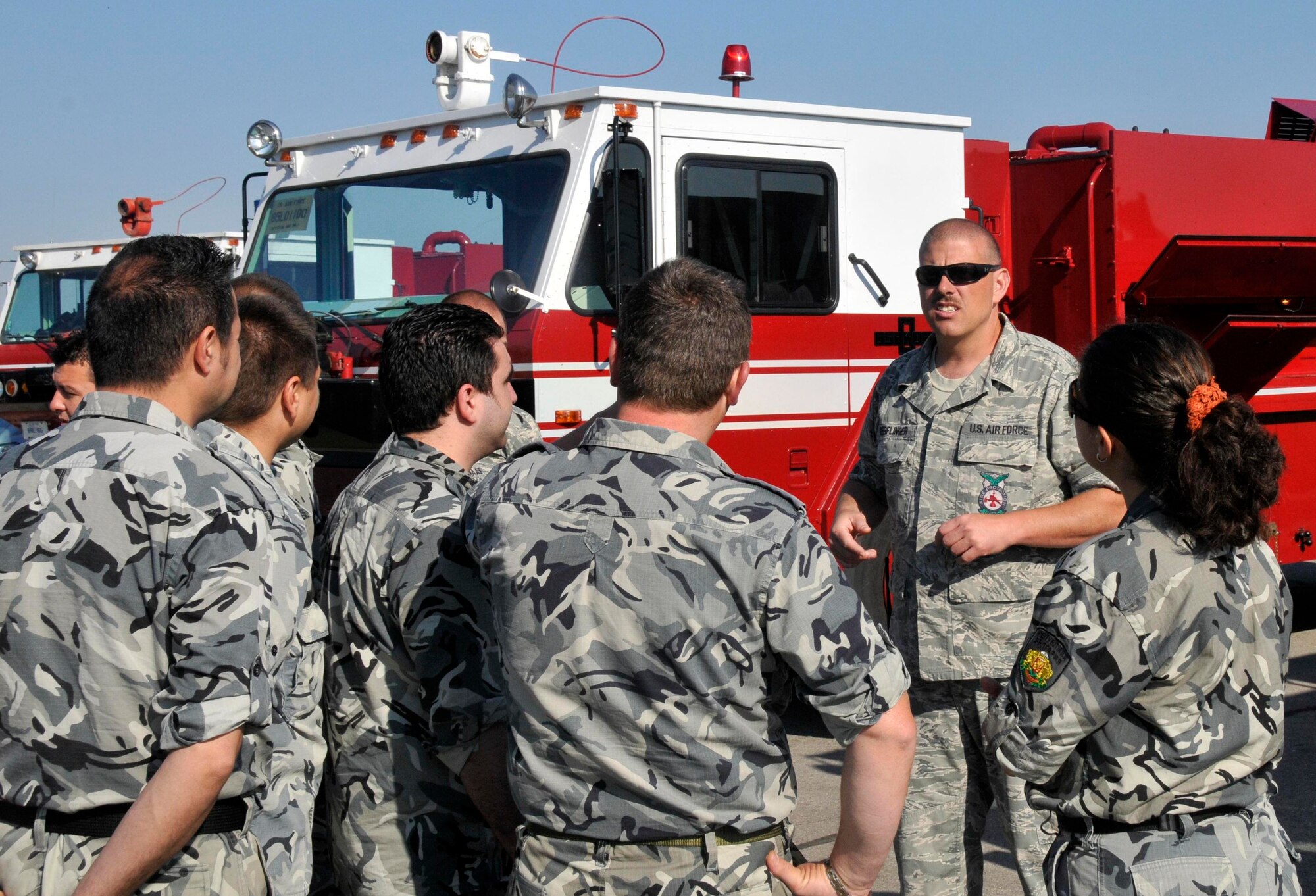 GRAF IGNATIEVO AIR FORCE BASE, Bulgaria - Tech. Sgt. Charles Derflinger (second from right), 48th Civil Engineer Squadron Fire Department station chief, introduces Bulgarian air force firefighters to the trucks U.S. Airmen use. Airmen from RAF Lakenheath, England, are at Graf Ignatievo Air Force Base in Bulgaria taking part in joint-exercise Sentry Gold, an exercise designed to continue the Bulgarian air force's integration into NATO and build partnerships between the two air forces. (Photo by Tech. Sgt. Chris Stagner)