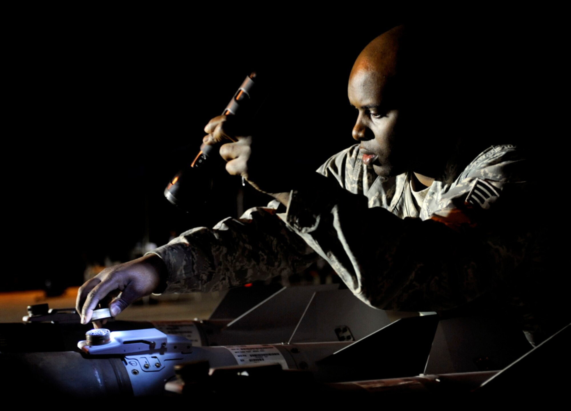 Staff Sgt. Brian Harp checks GBU12 munitions for technical accuracy in the in-check area of the bomb dump during the Combat Ammunitions Production Exercise at Osan Air Base, Republic of Korea, May 25. Sergeant Harp is a munitions maintainer from the 35th Munitions Squadron at Misawa Air Base, Japan. CAPEX is a non-rated exercise held once a year in the Pacific Air Force region. It provides training on non-nuclear reserve munitions production in integrated tasks orders and planning. (U.S. Air Force photo/Staff Sgt. Stephenie Wade)