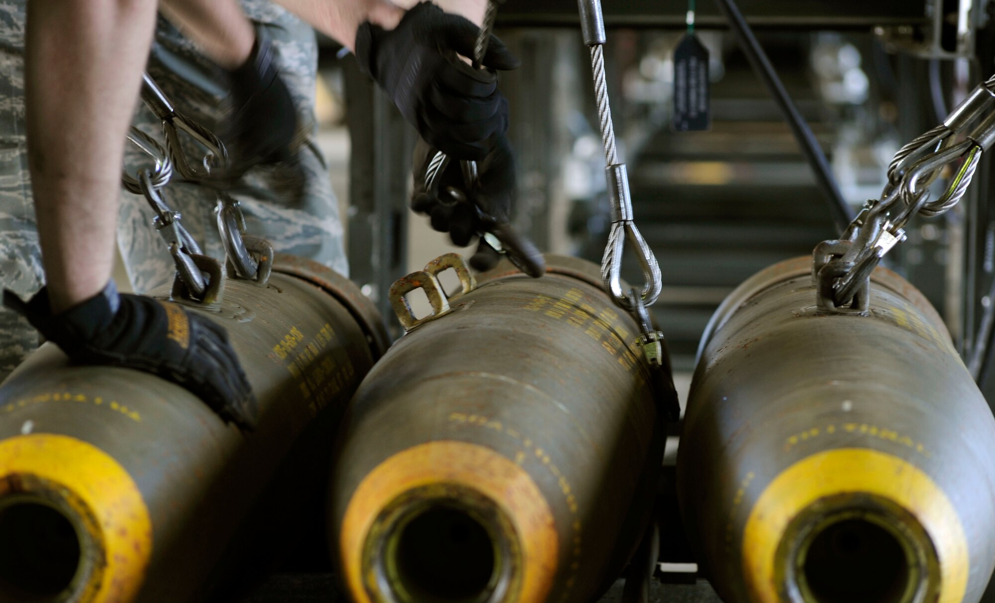 Senior Airmen Travis Talley and Derek White attach hooks to BLU-109 munitions before loading them onto a rolling rack to be assembled during the Combat Ammunitions Production Exercise at Osan Air Base, Republic of Korea, May 25. Airman Talley is a munitions maintainer from the 51st Munitions Squadron and Airman White is from the 35th Munitions Squadron at Misawa Air Base, Japan. CAPEX is a non-rated exercise held once a year in the Pacific Air Force region. It provides training on non-nuclear reserve munitions production in integrated tasks orders and planning. (U.S. Air Force photo/Staff Sgt. Stephenie Wade)
