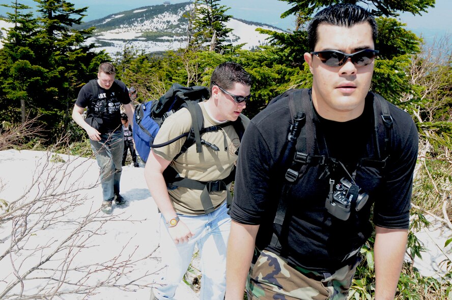 Airmen 1st Class Longinos Soto and Brian Mays, 301st Intelligence Squadron Misawa Security Operations Center and Airman Donald Moreland, Air Force Network Detachment 12, hike up the Japan’s northern Hakkoda mountain range May 22. Misawa Air Base Airmen in Japan enrolled in the Pacific Air Forces Command’s Ultimate Airman Adventure program can take advantage free or discounted outdoor excursions hosted by the 35th Force Support Squadron Outdoor Recreation. (U.S. Air Force photo/Senior Airman Jessica Lockoski) 