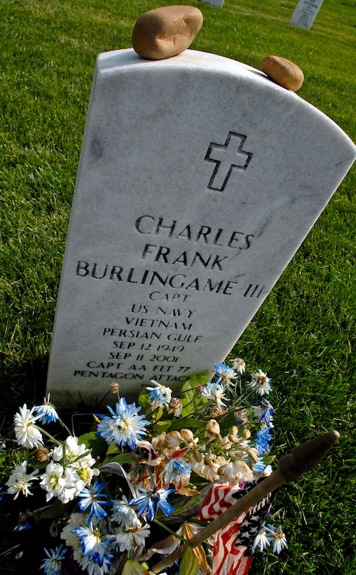 The marker of Charles Frank Burlingame III, pilot of American Airlines Flight 77 which  crashed into the Pentagon on Sept. 11, 2001 and a U.S. Navy veteran, is honored with a flag along with 350,000 others during the “Flags In” ceremony at Arlington National Cemetery, Arlington, Va., May 27, 2010.