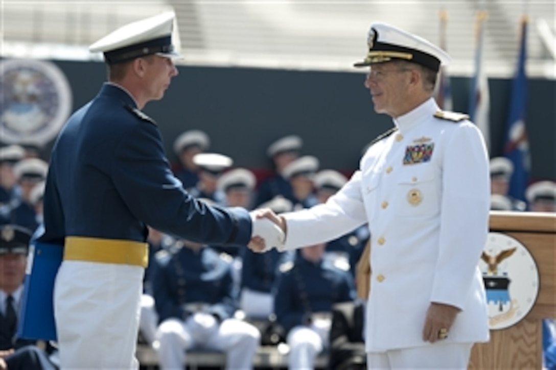 Chairman of the Joint Chiefs of Staff Adm. Mike Mullen (right), U.S. Navy, congratulates a U.S. Air Force Academy graduate at the school's commencement ceremony at Falcon Stadium in Colorado Springs, Colo., on May 26, 2010.  