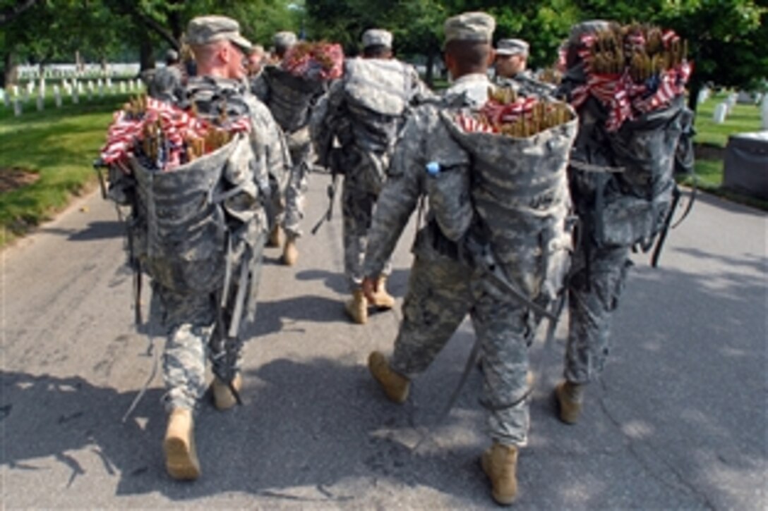 With flags in hand, members of the 3rd U.S. Infantry, The Old Guard, march out to their assigned sections during the “Flags In” ceremony at Arlington National Cemetery, Va., May 27, 2010. More than 1,500 servicemembers, Old Guard and other ceremonial units gathered for the sacred ritual that marks the start of the Memorial Day weekend observance.