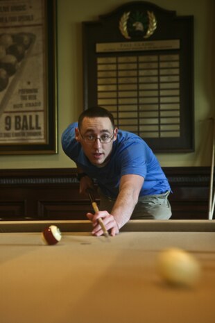 FARMINGDALE, N.J. - Lance Cpl. Sean Leyda plays pool during the Eagle Oaks Golf and Country Club Honor Day in Farmingdale, N.J., May 27. The annual Fleet Week event brought some 200 Marines and Sailors to the club for a day of golf and relaxation followed by a dinner party in their honor. More than 3,000 Marines, Sailors and Coast Guardsmen will be in the area participating in community outreach events and equipment demonstrations. This is the 26th year New York City has hosted the sea services for Fleet Week.::n::(Official Marine Corps Photo by Lance Cpl. Jad Sleiman)