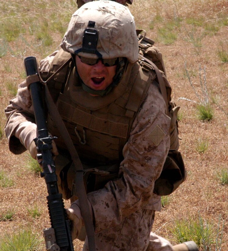 Cpl. Joe Eby, a fire team leader with Company K, 3rd Battalion, 25th Marine Regiment rushes to cover.
