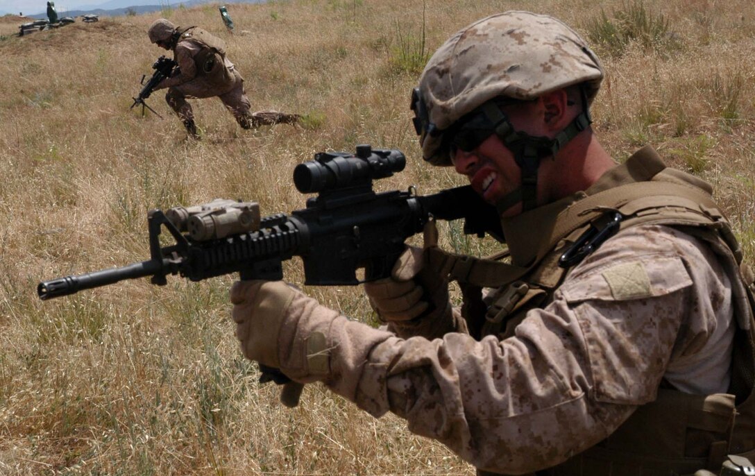 A Marine from Company K, 3rd Battalion, 25th Marine Regiment provides suppressing fire for his teammates.