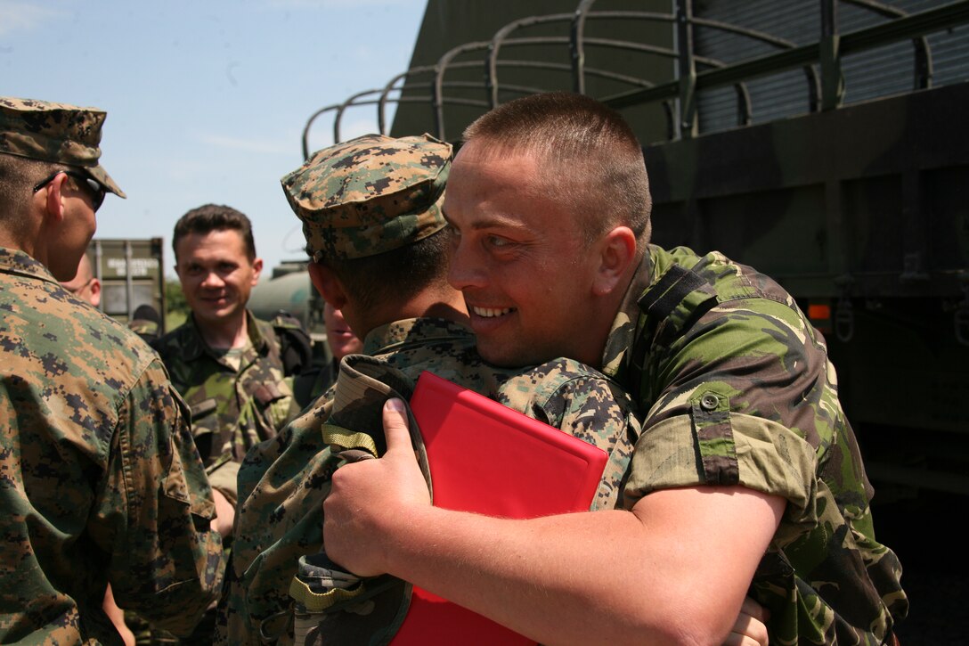 A U.S. and Romanian Marine say goodbye following the ceremony, May 28, closing two weeks of peacekeeping operations training. U.S. forces of Black Sea Rotational Force will now conduct peacekeeping operations training with Macedonian forces, and the Romanian forces are slated to begin airborne training with Black Sea Rotational Force's air combat element.