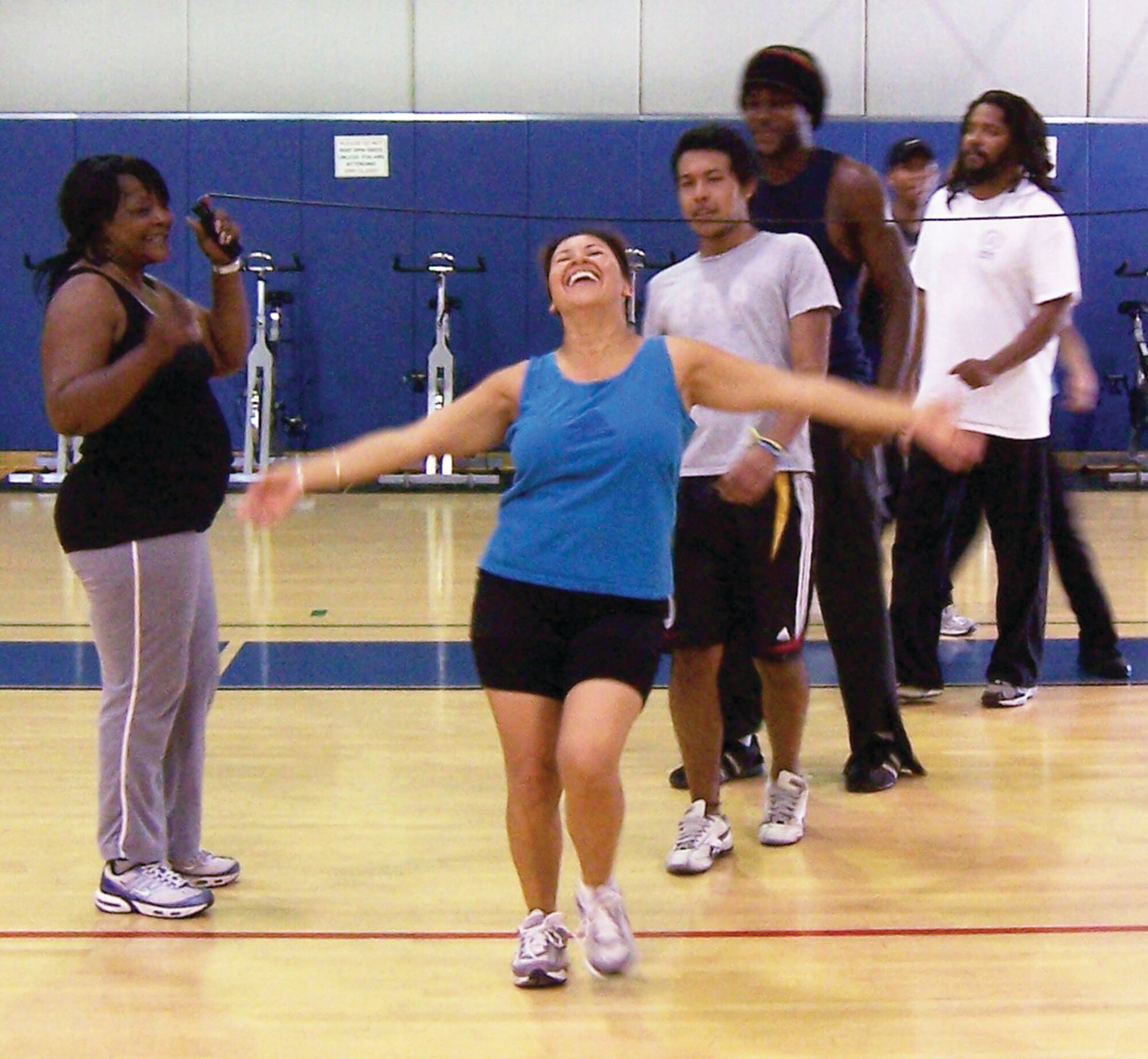 Mrs. Paez demonstrate just how low she can go during a round of limbo that was the final event in the "Old School Aerobathon" at the March Air Reserve Base Fitness and Sports Center. The Fitness Center organizes the two-hour Aerobathons quarterly as a way to create fun and challenging workout from a variety of types of exercise. Fifteen Team March members participated in the May Aerobathon, which included spinning, cardio kickboxing, mat work and limbo. Upcoming at the Fitness Center is a morning bike ride, bench press competition and a three-point shoot out competition.  (U.S. Air Force photo)