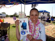 Staff Sgt. Aja Smith, 50th Aerial Port Squadron, holds a luminary bag she decorated in memory of her grandfather, a chief master sergeant who retired after a 30-year career in the Army Air Corps and Air Force. Sergeant Smith said her grandfather was a World War II, Korea and Vietnam veteran. He was first diagnosed with cancer in the early 1980s and battled it until he passed away in 2007. "He taught me to never give up on anything in life that challenges you," Sergeant Smith said. (U.S. Air Force photo by Jennifer McDow)