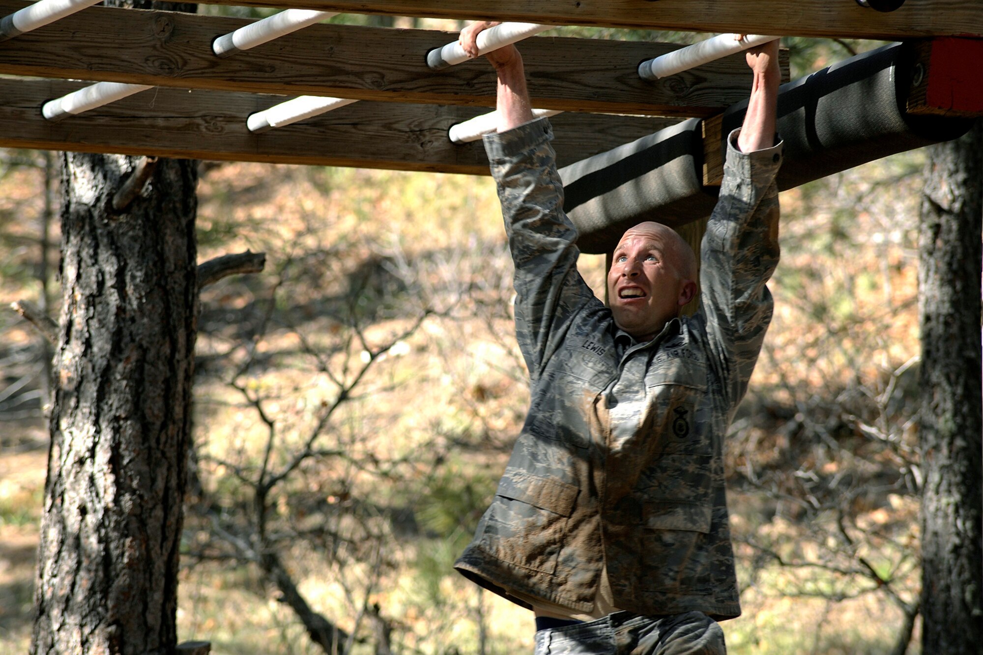 Staff Sgt. Andrew Lewis attacks an obstacle at the obstacle course trail at the U.S. Air Force Academy training area during the security forces competition May 18, 2010. He is a 50th Security Forces Squadron Guardian Challenge contender. (U.S. Air Force photo/Dennis Rogers)
