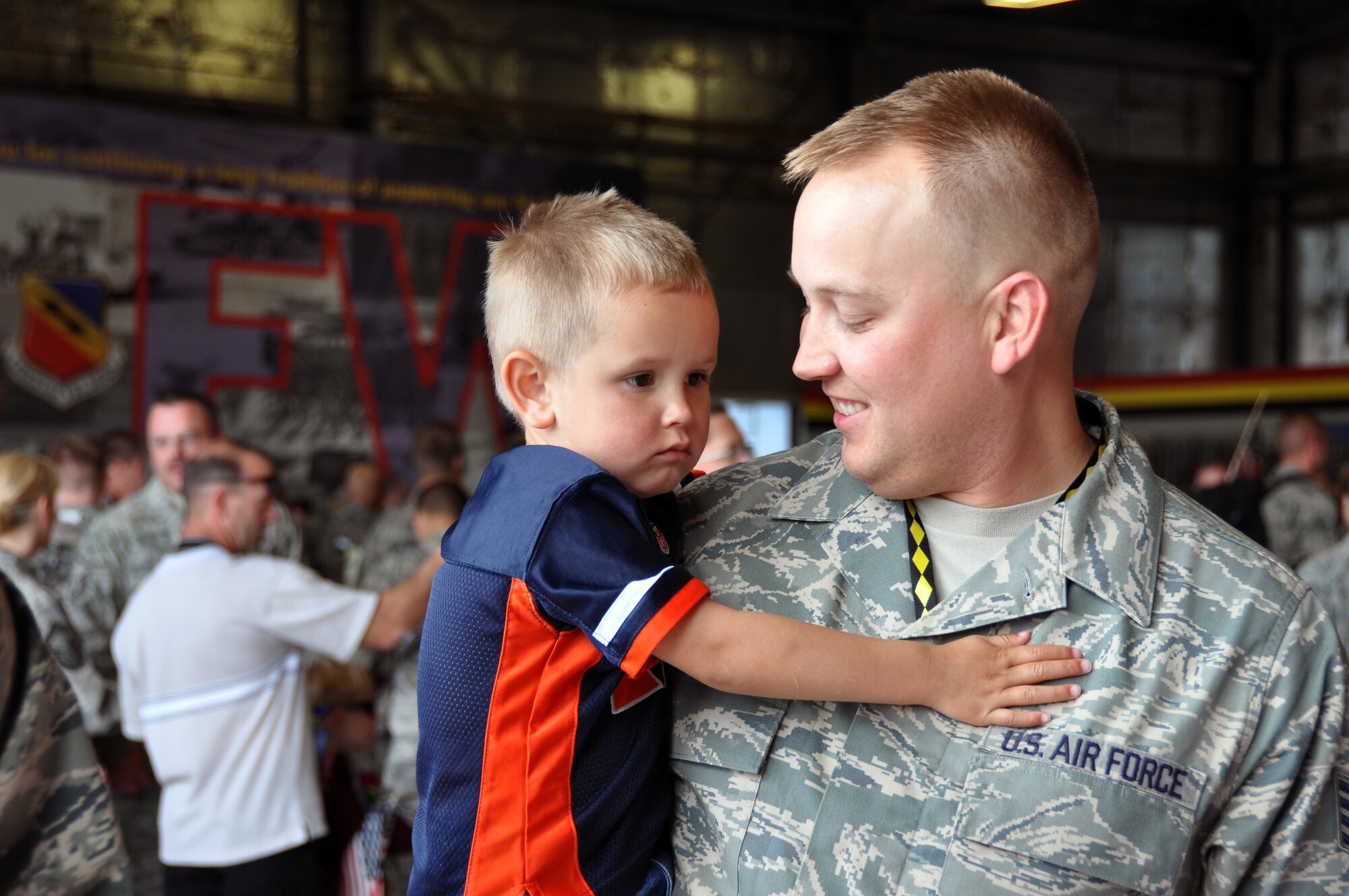 Staff Sgt. Nathan Nelson, 419th Aircraft Maintenance Squadron, holds his son, Luke. Sergeant Nelson was one of about 30 reservists from the 419th Fighter Wing to return to Hill Air Force Base from Afghanistan May 28. (U.S. Air Force photo/Bryan Magaña)