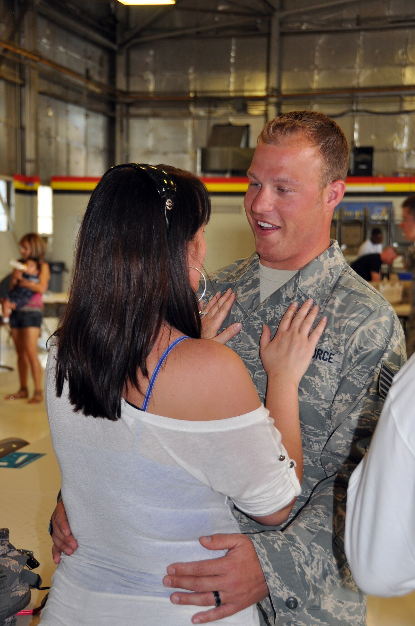 Tech. Sgt. Josh Rich, 419th Aircraft Maintenance Squadron, embraces his wife, Brandie. Sergeant Rich was among about 30 other reservists from the 419th Fighter Wing who returned from a nearly five-month deployment to Afghanistan May 28. (U.S. Air Force photo/Bryan Magaña)