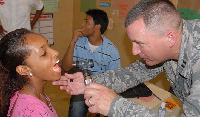 Capt. Craig Romero, a physician's assistant with the 927th Aeromedical Staging Squadron, MacDill Air Force Base, Fla., checks a Dominican patient during MEDRETE 2010 Dominican Republic on May 24, 2010. A team of 39 medical specialists from Air Force Reserve Command is providing medical care to four towns in the Puerto Plata region of the country. (U.S. Air Force photo/Master Sgt. Chance C. Babin)