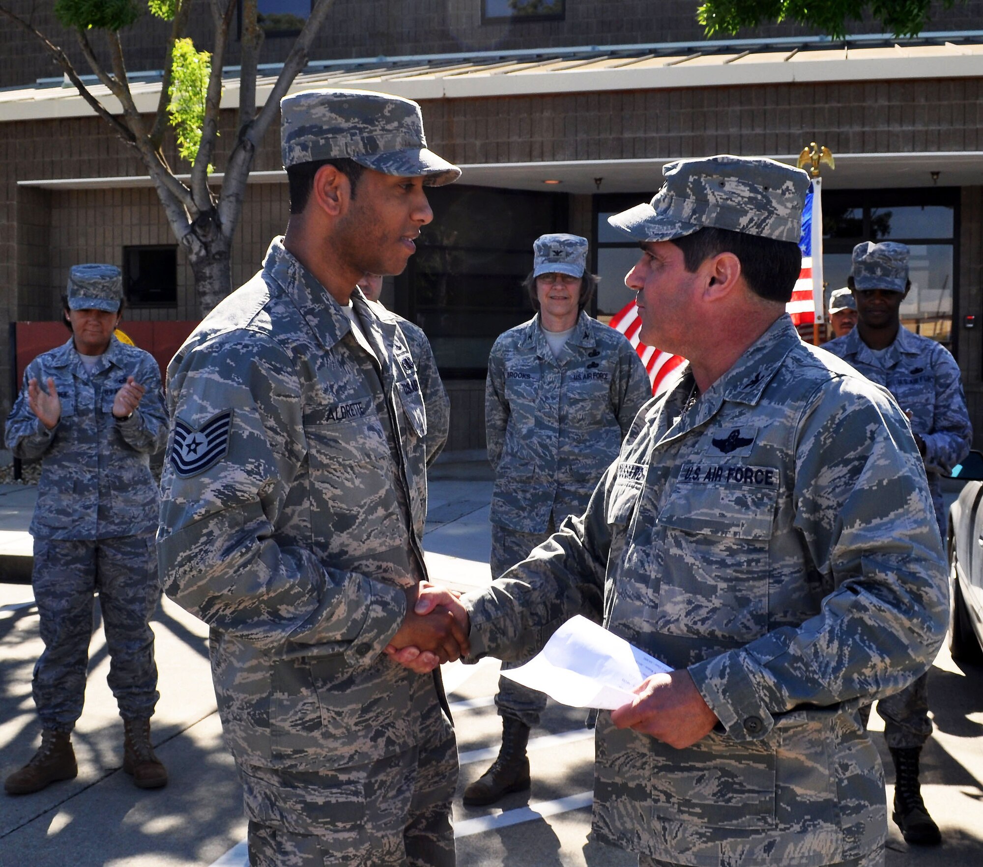 TRAVIS AIR FORCE BASE, Calif. -- Tech. Sgt. Mark Aldrette , 349th Civil Engineer Squadron, receives a 4th Air Force Commander's coin for superior performance from Col. Barrett Brousssard, 349th Air Mobility Wing vice commander May 2. A higher headquarters team made a staff assistance visit to the wing Apr. 28 - May 2 to assist in preparation for the 2011 operational readiness inspection. The numbered air force commander, Maj. Gen. Eric Crabtree, traditionally recognizes individual superior performance of duty with presentation of his personal coin. Sergeant Aldrette was one of four 349th CES Airmen coined. (U.S. Air Force photo/Senior Master Sgt. Ellen L. Hatfield)