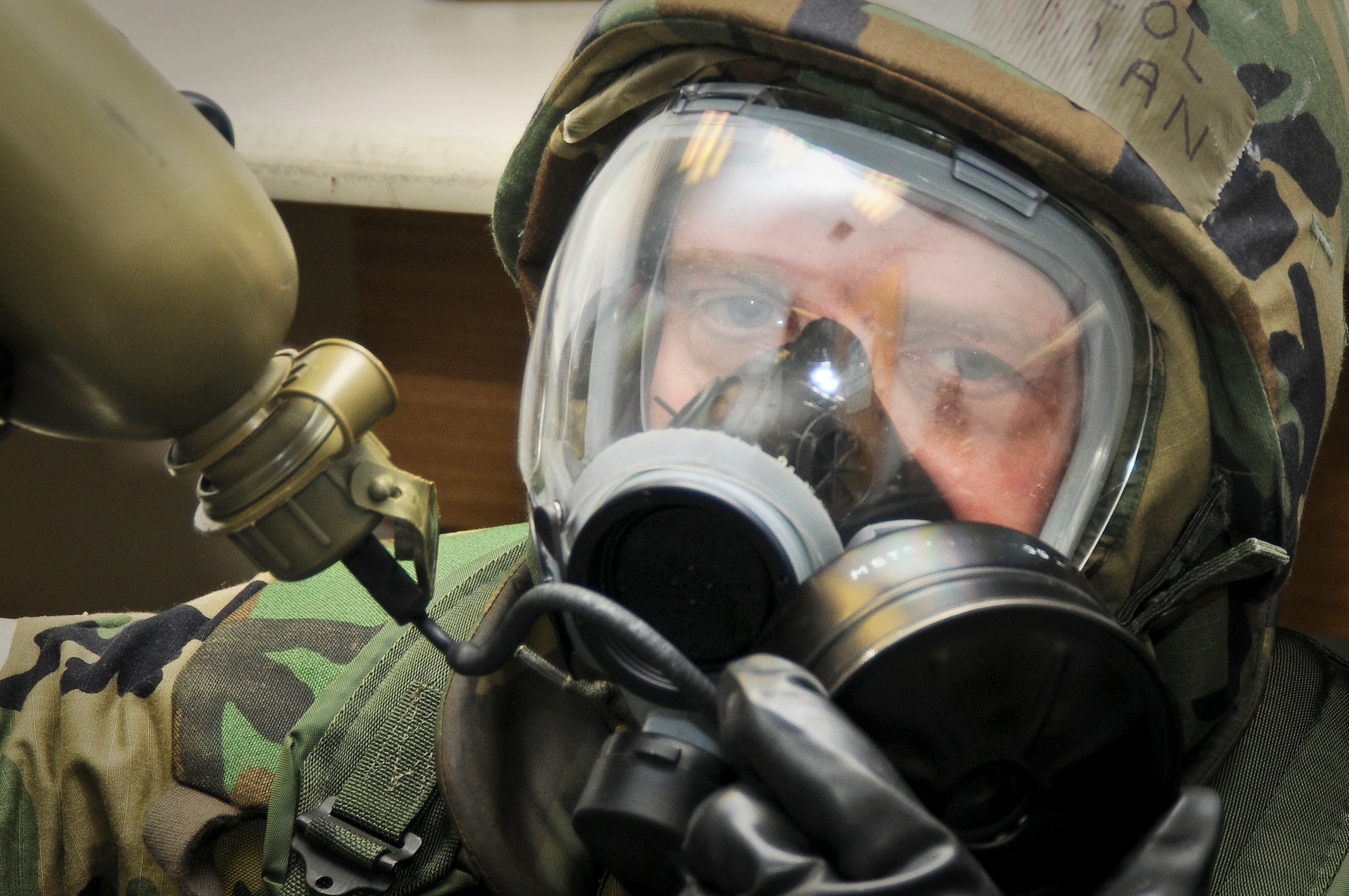 123rd Airlift Wing Chaplain (Lt. Col.) Fred Ehrman takes a drink from his canteen May 21, 2010 while under MOPP 4 conditions following a simulated chemical-weapons attack at the Gulfport Combat Readiness Training Center in Gulfport, Miss. The simulated attack was part of an Air Mobility Command Operational Readiness Inspection. (U.S. Air Force photo/Tech. Sgt. Dennis Flora)(Released)