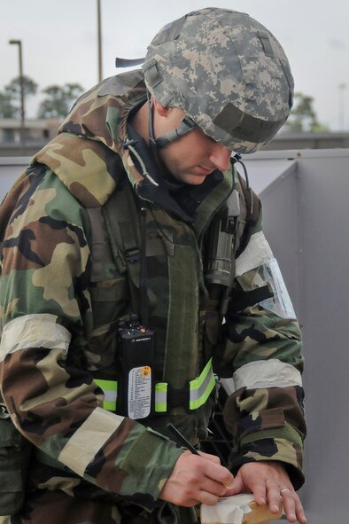An Air Force Post-Attack Reconnaissance Team member from the 123rd Airlift Wing inspects chemical detection devices in his perimeter on May 19, 2010 at the Gulfport Combat Readiness Training Center in Gulfport, Miss. The unit was participating in an Air Mobility Command Operational Readiness Inspection. (U.S. Air Force photo/Tech. Sgt. Dennis Flora)