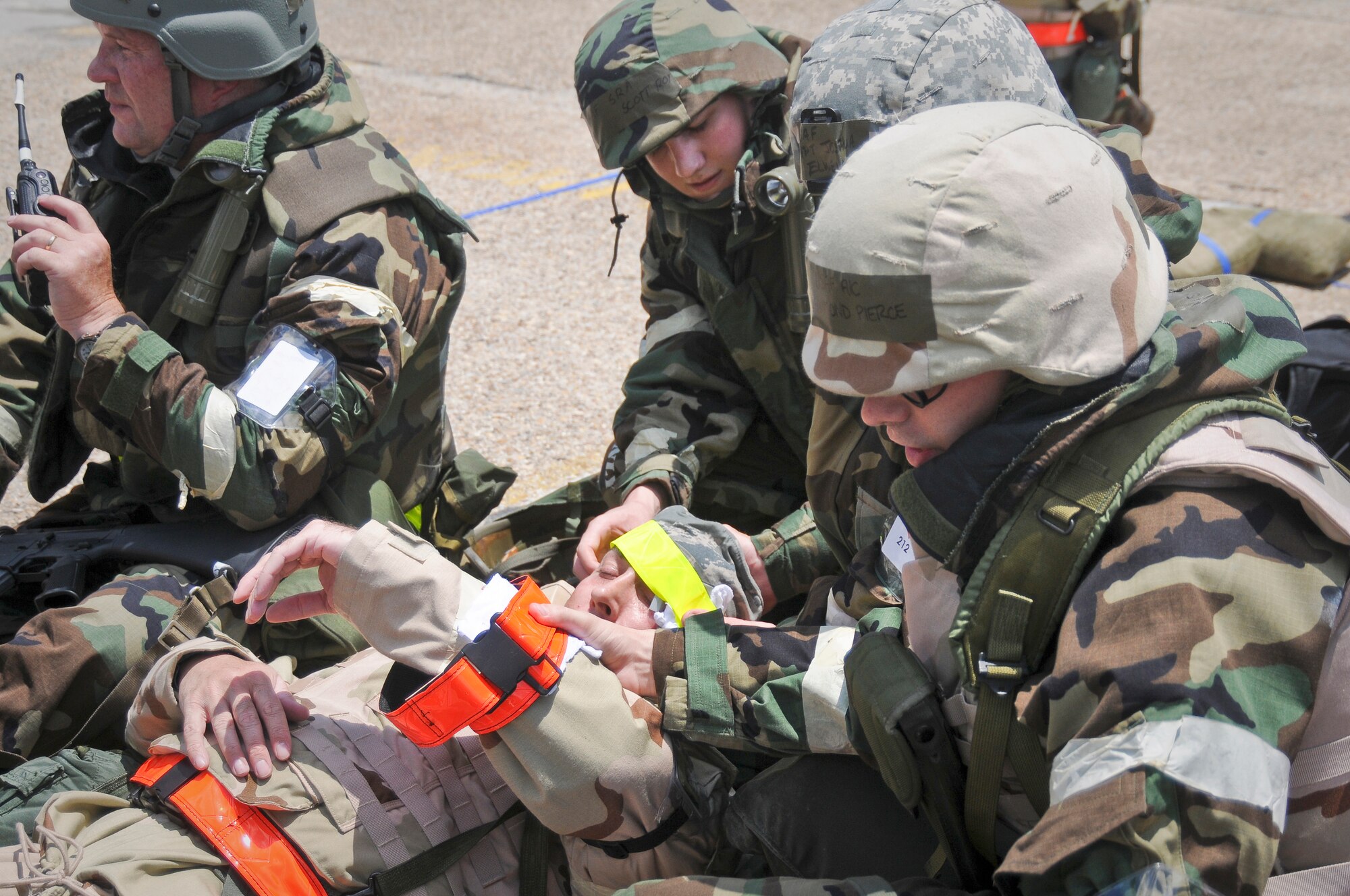 Members of the 123rd Airlift Wing render first-aid to a fallen Airman from the 317th Airlift Group after a simulated attack on their shared facilities May 20, 2010 at the Gulfport Combat Readiness Training Center in Gulfport, Miss. The two units, along with the 70th Aerial Port Squadron, were being evaluated for wartime readiness as part of an Air Mobility Command Operational Readiness Inspection. (U.S. Air Force photo/Tech. Sgt. Dennis Flora) (Released)