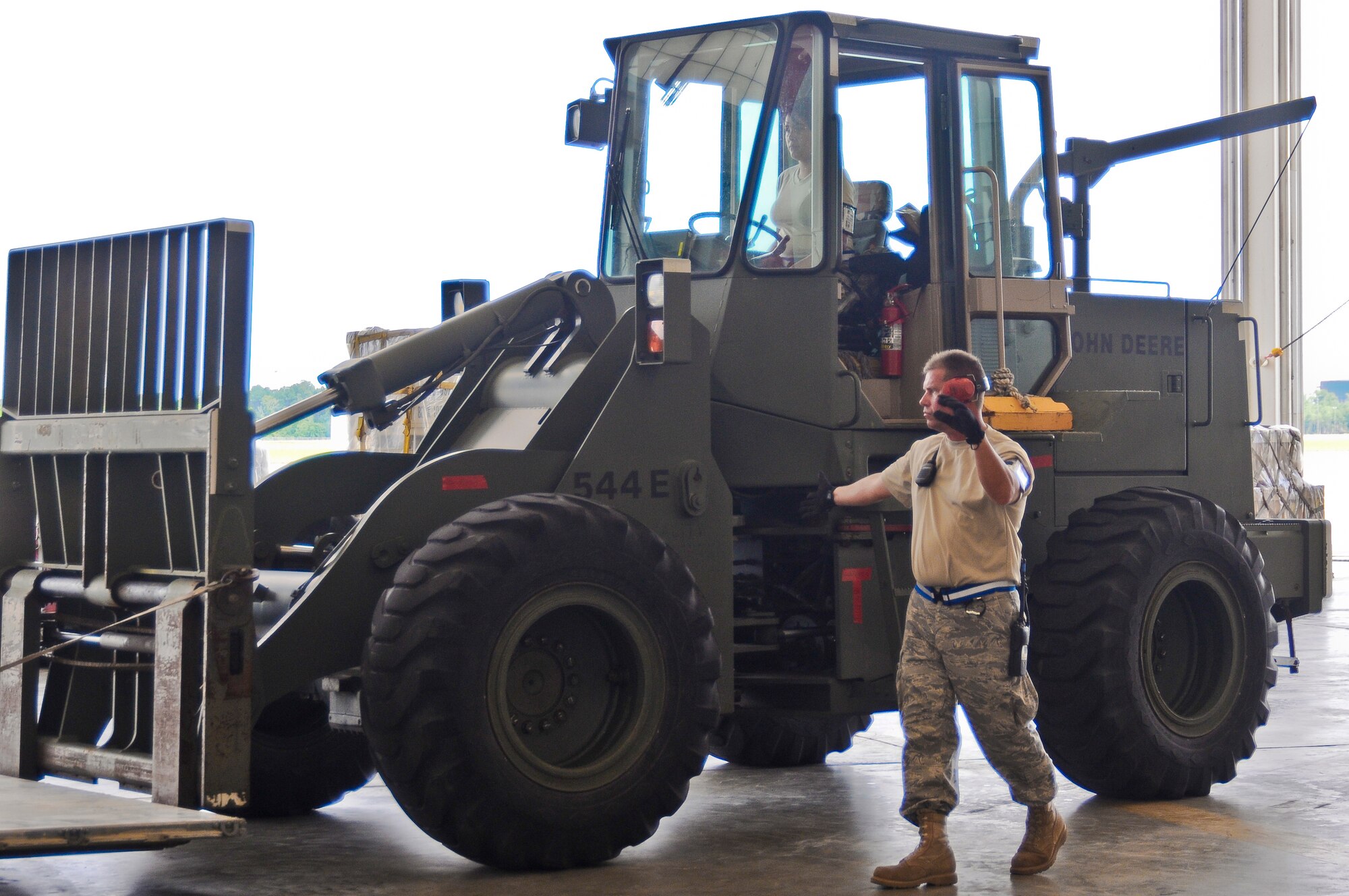 An Airman from the Air Force Reserve's 70th Aerial Port Squadron directs a forklift in the Main Hangar at the Gulfport Combat Readiness Training Center in Gulfport, Miss., on May 19, 2010. The cargo movement was part of an AMC Operational Readiness Inspection held in Gulfport from May 16-23. (U.S. Air Force photo/Tech. Sgt. Dennis Flora) (Released)