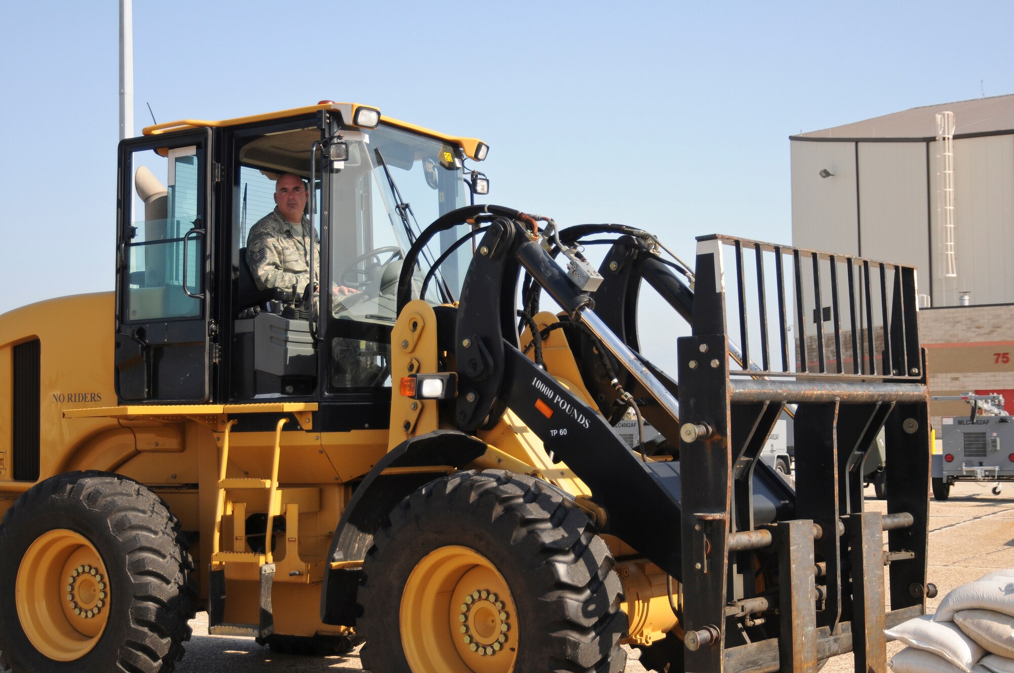 Tech. Sgt. Greg Smith, a heavy equipment operator from the 123rd Airlift Wing, transports sand bags for hardening of base structures May 19, 2010 at the Gulfport Combat Readiness Training Center in Gulfport, Miss. The wing was being evaluated as part of an Operational Readiness Inspection. (U.S. Air Force photo/Tech. Sgt. Dennis Flora) (Released)