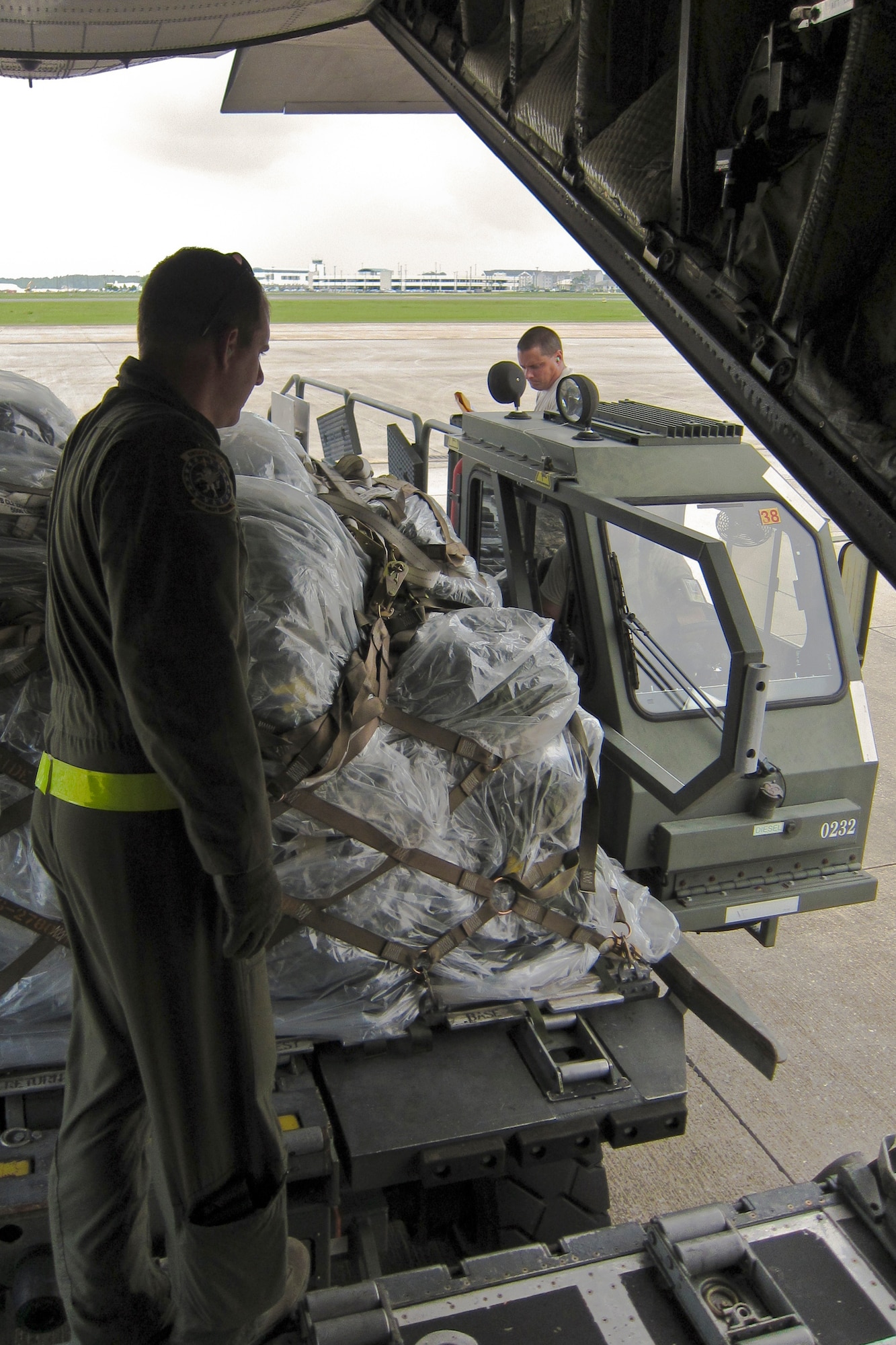 Loadmasters and ramp services personnel from the Kentucky Air Guard's 123rd Airlift Wing offload pallets of cargo from a C-130 onto a K-Loader at the Gulfport Combat Readiness Training Center in Gulfport, Miss., May 18, 2010. The wing was participating in an AMC Operational Readiness Inspection. (U.S. Air Force photo/Maj. Dale Greer)(Released)