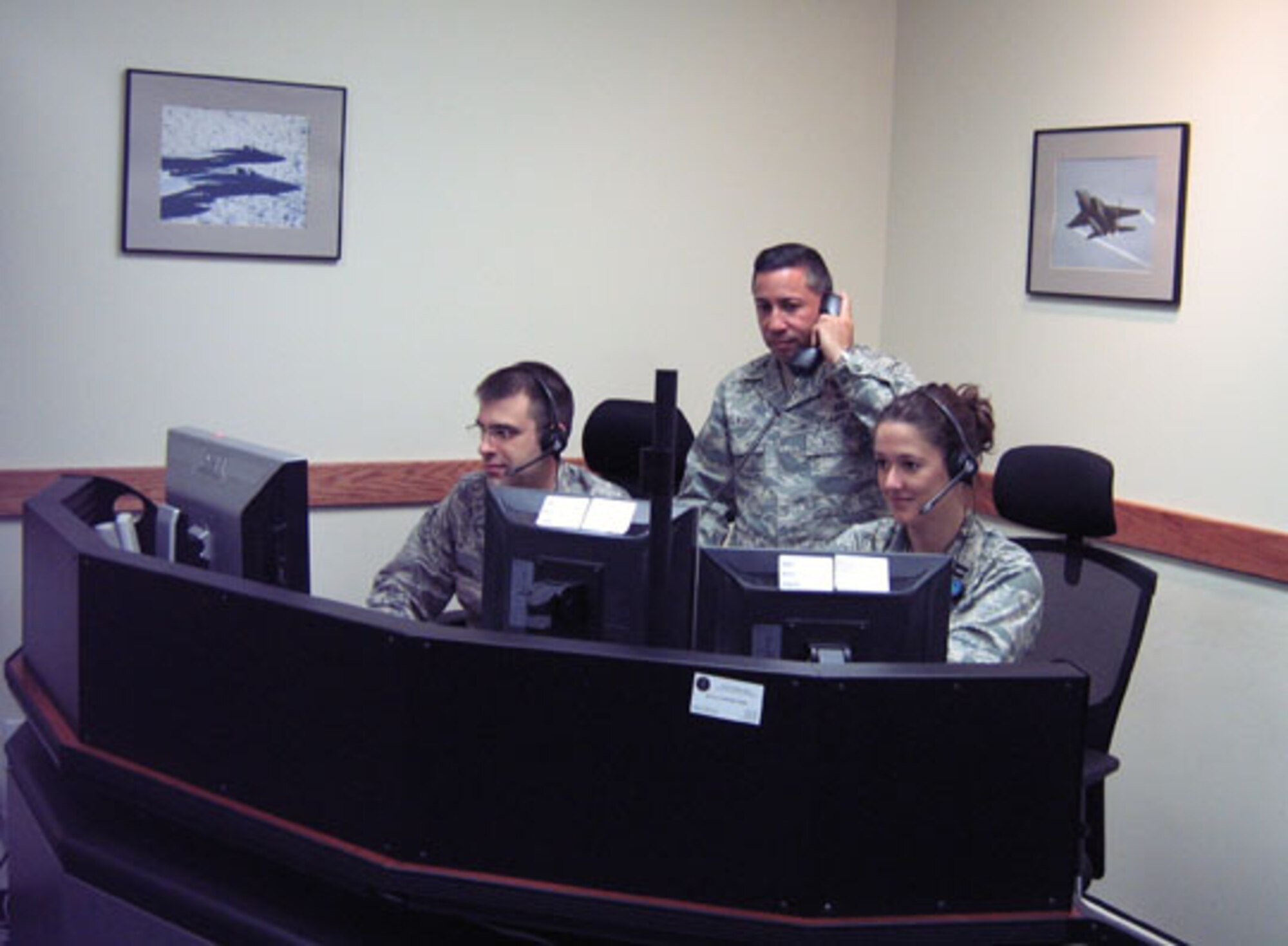 Captain Brendan Simison, Col. Frank Aflague and Capt. Sara Stockhaus, 102nd Air Operations Group, participated in the Joint exercise 'AUSTERE CHALLENGE -10', May 6-7.  The exercise gave the 102nd AOG an opportunity to prove the effectiveness of 'distributed operations' whereby the Massachusetts Air National Guardsmen supported the 608th Air and Space Operations Center, located at Barksdale AFB, La., from Otis Air National Guard Base, Mass., a distance of more than 1,200 miles.  (U.S. Air Force photo by Senior Airman Christopher Catyb)