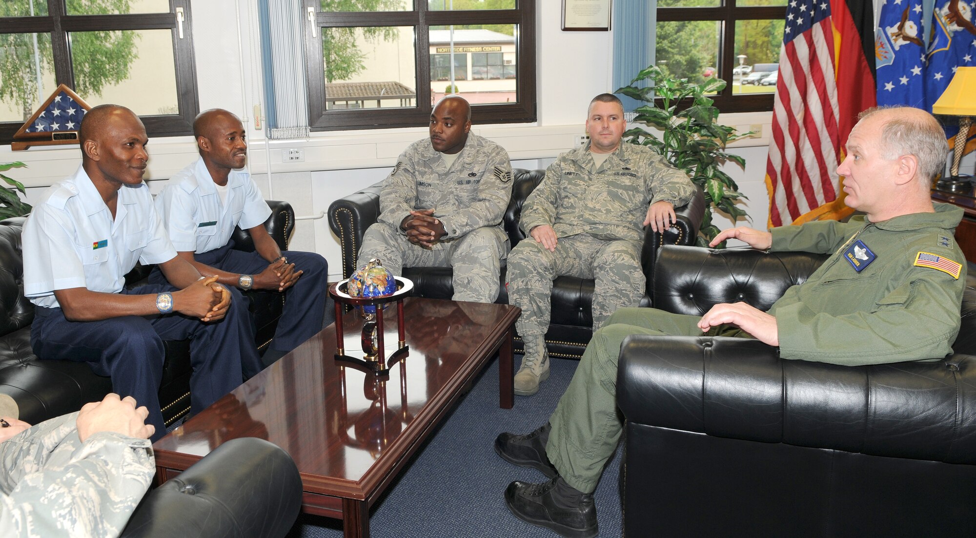 Maj. Gen. Ronald Ladnier, 17th Air Force commander, speaks with Ghana Air Force members at the 17th Air Force Headquarters building May 20. Warrant Officer’s Class II Kofi Dedoo and Noah Atsiagli came to Ramstein Air Base for an Aviation Maintenance NCO Exchange program designed to build on preventative maintenance efforts for Ghana’s aircraft fleet. Staff Sgt. Bronshay Limson and Tech. Sgt. Richard Linett escorted them during the two-week visit allowing them to get hands-on and visualize every aspect of how the 86th Aircraft Maintenance Squadron conducts business on a daily basis. The members were taken on the flightline and through the maintenance backshops to learn about U.S. procedures for managing flight schedules, parts, logistics, and maintainer safety and training. The two 86th AMXS NCOs are scheduled to travel to Ghana and work with the GAF for the second portion of the exchange. (U.S. Air Force photo by Staff Sgt. Stefanie Torres)