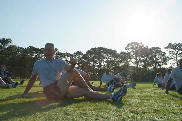HURLBURT FIELD, Fla. -- Chief Master Sgt. Martin S. Klukas, the command chief of Air Combat Command, stretches with 505th Command and Control Wing members during an early PT formation at Hurlburt Field, Fla., May 26. Klukas visited with Airmen and held Enlisted Calls at the 505th CCW and 53rd Wing at nearby Eglin Air Force Base, Fla. (U.S. Air Force photo by Bill Dowell)